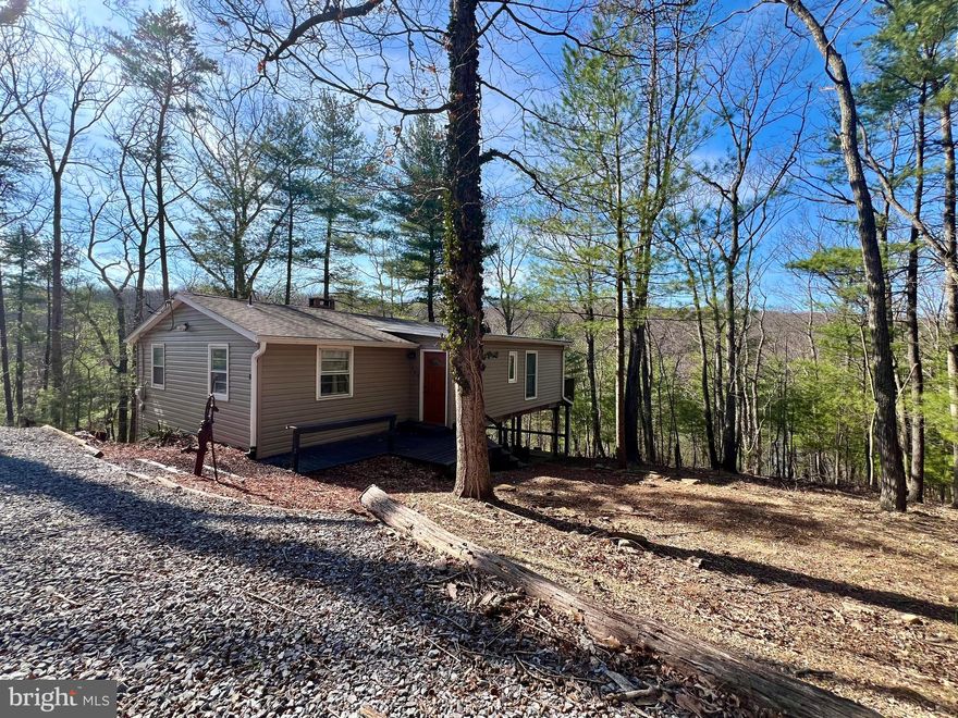 This 3 Bed/ 2 Bath single family home is an absolute show-stopper! Situated in the wooded Sleepy Hollow community located in Hedgesville, this home has a remarkable backyard lake view and access!

A spacious deck wraps from the outside of the kitchen to the outside of the Primary Bedroom granting easy access to the breathtaking view. Additional features include a stackable Washer/ Dryer, Outdoor shed for storage, and a decorative wooden fireplace in the living room for tenants to enjoy.

Rent Includes:
- Private Water/ Sewer
- Renters Insurance
- Second Nature Air Filter (HVAC Filter Subscription)

Pets are a Case by Case basis.

EHO.