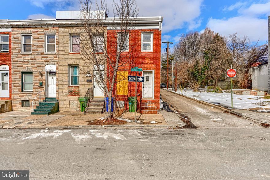 Discover an exceptional investment opportunity in the heart of the vibrant Hollins Market neighborhood! This end-of-row townhouse, built in 1920, boasts a classic Federal architectural style with a timeless brick façade that exudes character and curb appeal. Step inside to find an inviting open floor plan with hardwood floors that seamlessly blends the living and dining areas. The kitchen, designed with a country flair and consists of black stonemark granite countertop, wood cabinets and appliances, offers ample table space for casual dining. Enjoy spacious room sizes in the bedrooms, creating a comfortable retreat. The full bathroom features a tub shower, providing both functionality and style. The unfinished finished basement offers additional space for storage or future expansion, maximizing your investment's value. The property sits on a desirable corner lot, enhancing its street presence and potential for outdoor enhancements. With sidewalks and streetlights, the exterior is not only attractive but also promotes a safe and walkable community. Investors will appreciate the urban location, which is poised for growth and development, ensuring strong rental demand and potential appreciation.  With city and street views, this property is a rare find in a thriving area. Don't miss out on this opportunity to secure a piece of real estate in a location that promises both lifestyle and investment potential!