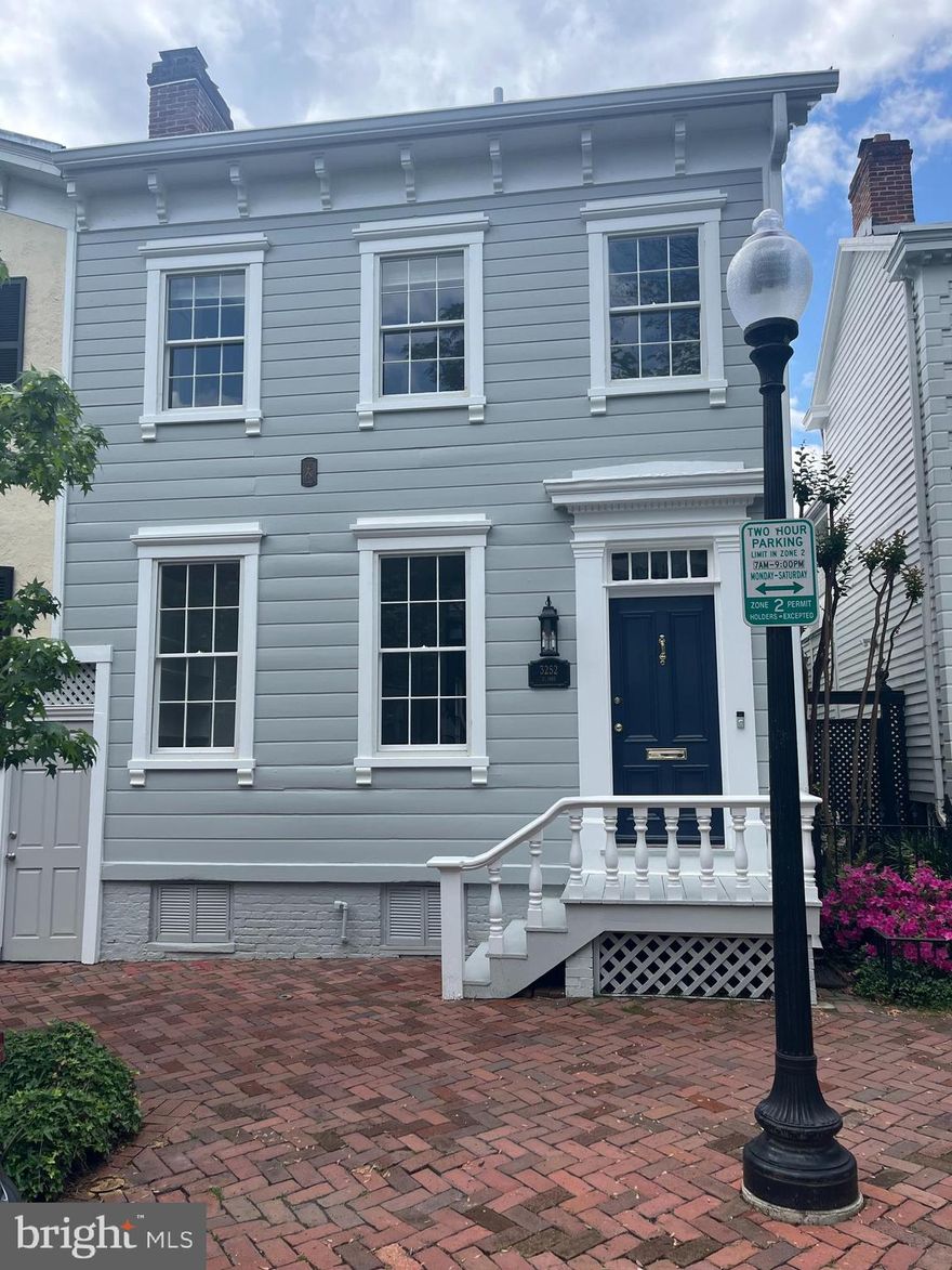 Elegant Federal-Style Home with Two-Car Garage and Garden Oasis in the heart of Georgetown. This gracious 4BR/3.5BA home seamlessly blends historic charm with modern comfort. The renovated kitchen and adjoining family room feature a cozy fireplace and expansive south-facing windows that frame views of the deep, sunlit garden. Original hardwood floors and intricate millwork, including floor-to-ceiling built-ins in the living room, highlight the home’s timeless character. A flexible lower-level suite offers in-law or guest potential, while the detached 2-car garage—with an adjoining potting shed—is a rare and valuable amenity in the city.