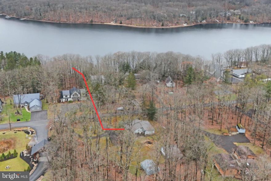 Lovely level lot with path to your own private class A dock, directly across the street. This comfy cottage sits on 1.8 level acres with 2 storage garages and mature landscaping. 5BRs, open living, dinning & kitchen area, with lots of sunlight.  1 full & 1-1/2 bath, large closet for storge, laundry room off back of the home.   2 garages with plenty of storge for your lake and yard toys.  The lot has mature landscaping and circular paved driveway, for easy in and out during all seasons.  Private path to your lakefront dock is across the street.  Great opportunity to get onto the lake at an affordable price, call agent to set up an appointment or with any questions.  This sale includes 2 parcels, home & lakefront parcel, buydown included.