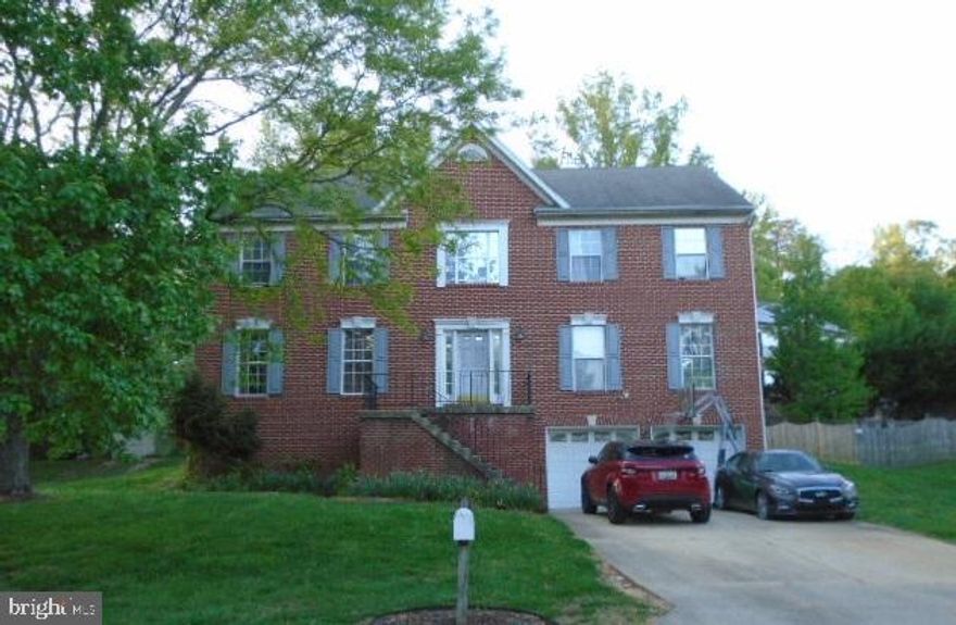 Brick front, 2-car garage, deck.