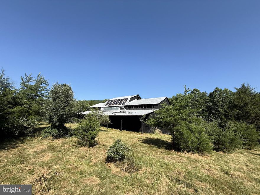 Rare offering of three lots in the quiet Trout Pond community totaling 7.14 acres with pastures, beautiful views, and a running stream. Two parcels are unimproved, while one features an old converted barn that was once used as a residence. A full renovation was started but never completed, leaving the structure in need of significant work. The building may be salvageable, but it is being sold strictly as-is. An existing well and septic system are located on the lot with the structure.  This property is subject to the covenants and restrictions of the Trout Pond Property Owners Association, but it can be developed, and short-term rentals are allowed. With its natural beauty and prime location, this is a great opportunity for someone with vision and creativity to bring new life to the property and create something truly special.  Enjoy peace and privacy surrounded by the George Washington National Forest, with access to nearby hiking trails and all the amenities of the Lost River Valley. THREE LOTS INCLUDED 7.14 Acres total: Lot A-51 – 2.47 acres, Lot A-18 – 2.56 acres, Lot A-52 – 2.11 acres