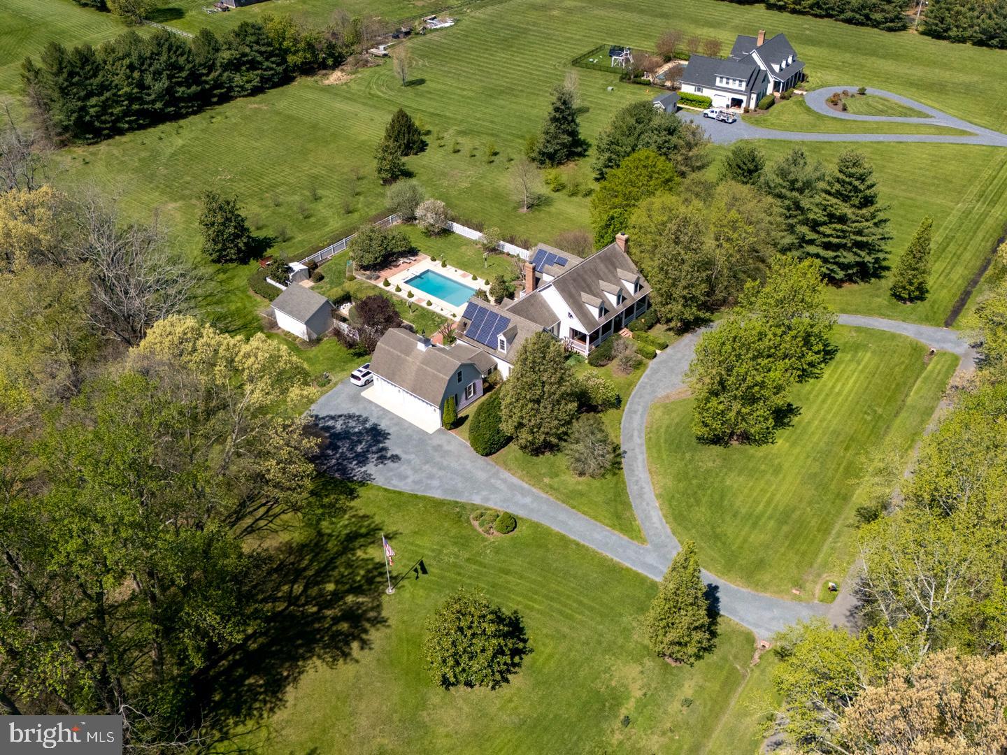 “Berry Hill” – part of the Southern Living Historical House Collection, this Coastal Cape sits on 5.8 acres and features: 4 bedrooms, 4 full and 2 half baths; a Primary Suite on the first floor as well as an office/bedroom with a full bath; hardwood flooring, 10’ ceilings on first floor; kitchen with granite, ss appliances, an island, breakfast room, and a walk in pantry; There is a walk in coat closet coming from the garage into the house; Utility room with front loader washer and dryer and a soaking sink, desk, refrigerator and numerous cabinets; separate formal dining room; formal living room with masonry fireplace; large family room with masonry fireplace with electric insert; The primary bedroom has large sunny windows with a view of the pool and gardens, private access to a back deck, and a large walk-in closet with a built in closet organizer system. The primary bathroom has a tiled and glass shower, double vanity sinks, and a 6’ whirlpool tub.
There are two staircases in this home, one off the foyer and the other off the kitchen, leading up to a large bonus room on the second floor. A hallway from the bonus room takes you across the balcony overlooking the family room to the rest of the second floor, which has 3 bedrooms, one with an ensuite bathroom. There is an additional full bath. All 3 bedrooms have walk in closets. There are also 3 large storage closets on the second floor and two linen closets.
There is an attached 3 car garage with 10’ foot doors, a second floor and a workshop. Other features include: 29 Solar Panels (paid for) and average utilities are $100/month; New heat-pump Hot Water Heater (65 gallon); 2 zone HVAC; De-Nitrification Septic System; Electric Car Charger; The property is improved with a 14’ X 20’ outbuilding for lawn tractor/tools, an 8’ X 10’ garden shed, an inground pool (new liner in 2023) with full fencing, mature landscaping, circular driveway. Incredible location, on a private road, minutes to historic downtown Easton MD. No HOA! Horses permitted.