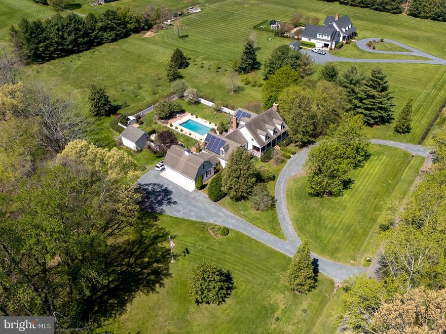 “Berry Hill” – part of the Southern Living Historical House Collection, this Coastal Cape sits on 5.8 acres and features:  4 bedrooms, 4 full and 2 half baths;  a Primary Suite  on the first floor as well as an office/bedroom with a full bath;  hardwood flooring, 10’ ceilings on first floor;  kitchen with granite,  ss appliances, an island, breakfast room, and a walk in pantry;  There is a walk in coat closet coming from the garage into the house;  Utility room with front loader washer and dryer and a soaking sink, desk, refrigerator and numerous cabinets; separate formal dining room;  formal living room with masonry fireplace;  large family room with masonry fireplace with electric insert;  The primary bedroom has large sunny windows with a view of the pool and gardens,  private access to a back deck, and  a large walk-in closet with a built in closet organizer system. The primary bathroom has a tiled and glass shower, double vanity sinks, and a 6’ whirlpool tub. 
 There are two staircases in this home, one off the foyer and the other off the kitchen, leading up to a large bonus room on the second floor.  A hallway from the bonus room takes you across the balcony overlooking the family room to the rest of the second floor, which has 3 bedrooms, one with an ensuite bathroom. There is an additional full bath. All 3 bedrooms have walk in closets. There are also 3 large storage closets on the second floor and two linen closets. 
There is an attached 3 car garage with 10’ foot doors, a second floor and a workshop. Other features include:  29 Solar Panels (paid for) and average utilities are $100/month; New heat-pump Hot Water Heater (65 gallon);  2 zone HVAC;  De-Nitrification Septic System;  Electric Car Charger;  The property is improved with a 14’ X 20’ outbuilding for lawn tractor/tools,  an 8’ X 10’ garden shed, an inground pool (new liner in 2023) with full fencing, mature landscaping, circular driveway. Incredible location, on a private road, minutes to historic downtown Easton MD.  No HOA! Horses permitted.