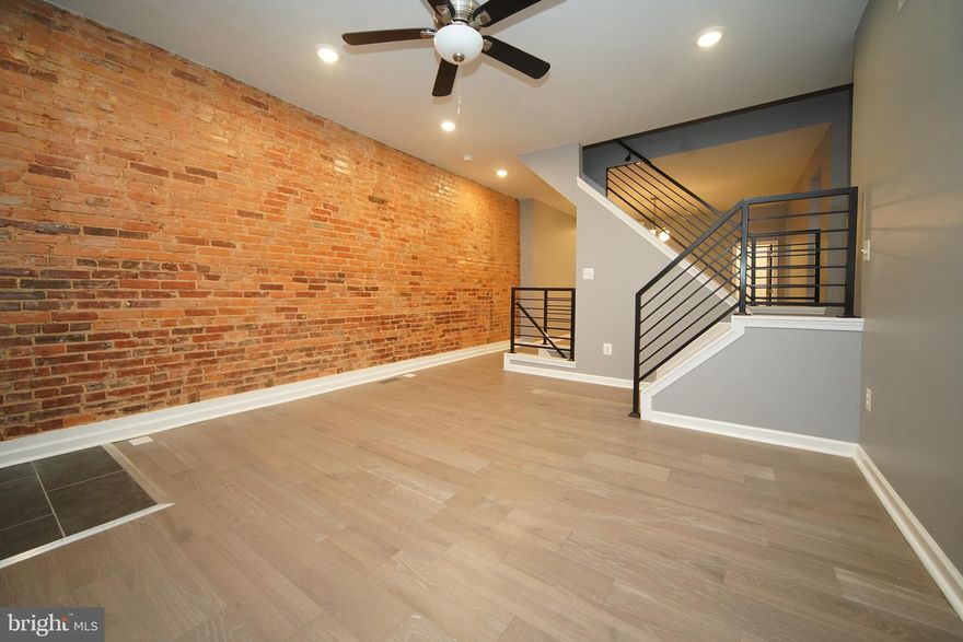 This newly renovated porch front home boasts 3 bedrooms, 2 bathrooms, a spacious lower level and a fenced rear yard. The kitchen features stainless steel appliances and an island with seating. Separate dining and living room areas, hardwood floors and exposed brick walls are among the many features of this home.  Schedule your showing today!