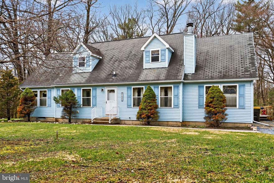 Showings start at Open House this Saturday March 28th 10 AM.. Lovingly cared for Cape Cod offering an impressive 2,274 sq ft of living space, perfectly set on a picturesque 1-acre partially wooded lot. Spacious home features 3 bedrooms plus a versatile loft and 2.5 baths. The inviting main level includes a welcoming family room with a wood-burning fireplace and beautiful stone hearth, along with a formal living room and dining room. The main-floor primary suite boast a large walk-in closet and a private bath with garden tub, dual vanity, and oversized shower. Kitchen offers a breakfast bar, dining space, pantry, electric range, microwave, and a newer Bosch dishwasher. Upstairs, you’ll find a generous loft area, two spacious bedrooms, a full bath, and additional attic storage. Step outside to enjoy the peaceful natural setting featuring a charming creek with footbridge, perfect for relaxing or exploring. The wrap-around deck provides plenty of space for outdoor entertaining or quiet mornings surrounded by nature. Additional highlights include two driveways, a full unfinished basement with wood stove offering endless possibilities, well water with public sewer, and plenty of storage throughout. A rare opportunity to own a home with space, character, and a serene setting—don’t miss it!