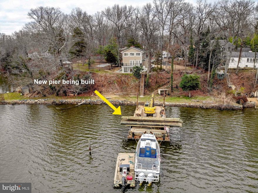 This beautifully remodeled, 4-bedroom, 3-bathroom South River Waterfront residence in the highly sought-after neighborhood of Cape St John is a true gem. Step into luxury living with a brand-new pier boasting an impressive 8-foot mean low water depth, currently being installed. This exquisite waterfront home boasts a first-floor primary bedroom suite, complete with a generously sized walk-in closet and a spa-like primary bathroom with ceramic tiles and an oversized shower, offering unparalleled comfort and convenience. The kitchen is a chef's dream, featuring pristine white cabinets complemented by a sophisticated butcher block countertop and stainless steel appliances. Seamlessly connected to the family room, which features a cozy wood-burning fireplace, it creates a warm and inviting atmosphere for both everyday living and entertaining. Indulge in breathtaking views of the South River from the sunroom, a perfect place to unwind, or host intimate gatherings with loved ones. Extend your entertainment space with a deck off the dining/sunroom area, seamlessly blending indoor and outdoor living while soaking in the picturesque views. Venture upstairs to discover a loft area boasting walls of glass that offer expansive views of the water—a versatile space ideal for a home office or a charming gathering area. Completing the second level are two generously sized bedrooms and a beautifully appointed full bathroom. The lower level offers a haven for relaxation and entertainment with a spacious recreation room featuring a mini bar, an additional bedroom, and another full bathroom. Step out to a lower-level covered patio, perfectly positioned to maximize the stunning views. Situated in the amenity-rich neighborhood of Cape St John, this home offers not just a picturesque waterfront lifestyle but also the convenience of being centrally located close to downtown Annapolis with easy access to major highways. This is an extraordinary opportunity to own a magnificent waterfront home in an idyllic location with deep water access—truly a must-see!