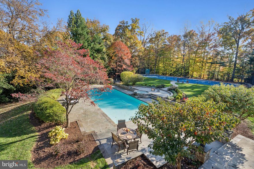 Set on a breathtaking and exceptionally private 1.25-acre cul-de-sac lot, this distinguished estate offers a rare blend of elegance, serenity, and resort-style living. The beautifully landscaped, fully fenced grounds, unfold like a private retreat, where a heated pool and waterfall hot tub, regulation tennis court, and expansive outdoor spaces invite both lively entertaining and quiet moments of reflection. Mature blooming trees, expansive lawns, and gorgeous greenery create your own private oasis.

One enters through custom-designed double doors into a dramatic two-story foyer, where a magnificent crystal chandelier with motorized lift, is suspended above a graceful curved staircase, setting an immediate tone of elegance. Beyond, the home opens to refined, light-filled interiors rich in architectural detail and timeless design. The family room, framed by floor-to-ceiling windows, is filled with an abundance of natural light, creating a warm and inviting central gathering space.

The dining room, adorned with Venetian plaster walls, a striking gold leaf alcove, and Schoenbeck chandelier, embodies both sophistication and artistry, evoking merry filled formal meals with family and friends. Also featured is a peaceful sunroom—bathed in natural light—revealing sweeping views of the grounds, while the gourmet kitchen, butler's pantry, and surrounding living spaces are thoughtfully arranged for both everyday comfort and effortless entertaining. A stunning Conservatory with soaring ceilings provides exceptional versatility, ideal as a children’s study, artist’s studio, or an elegant gathering space. Completing the main level, a handsome library with custom built-in bookshelves offers a quiet and refined setting for work or retreat.

Upstairs, the primary suite is a true sanctuary, offering a gracious sitting room with a balcony overlooking the grounds, a fireplace, and separate sleeping quarters.  The primary bath and closets have been expanded, exquisitely reimagined and adorned with luxurious finishes and sparkling Swavorski crystal light fixtures that elevate the space to a spa-like experience. Relax in your soaking tub or in an invigorating shower with numerous shower heads and body sprays. The custom closet room boasts a beautifully appointed custom shoe salon, an oversized island with marble top and drawers for storage, as well as numerous built-in shelving areas. The five additional en suite bedrooms offer comfort and privacy, while a thoughtfully designed build-out over the garage features a full bath and sauna, and private balcony, perfect for guests, wellness, or a private retreat.

The expansive walk-out lower level is designed for both indulgence and entertaining, featuring a kitchen and bar, home cinema, exercise room, billiards area, bedroom, and full bath. A spacious recreation room anchored by a warm, inviting fireplace offers a comfortable gathering space, while a separate dining area opens gracefully to the pool, creating an ideal setting for relaxed indoor-outdoor living.
With a four-car garage, a graceful connection between interior and exterior living spaces, and an unparalleled sense of privacy, this extraordinary residence offers a lifestyle defined by beauty, comfort, and quiet sophistication. Truly the premier lot in The Reserve!