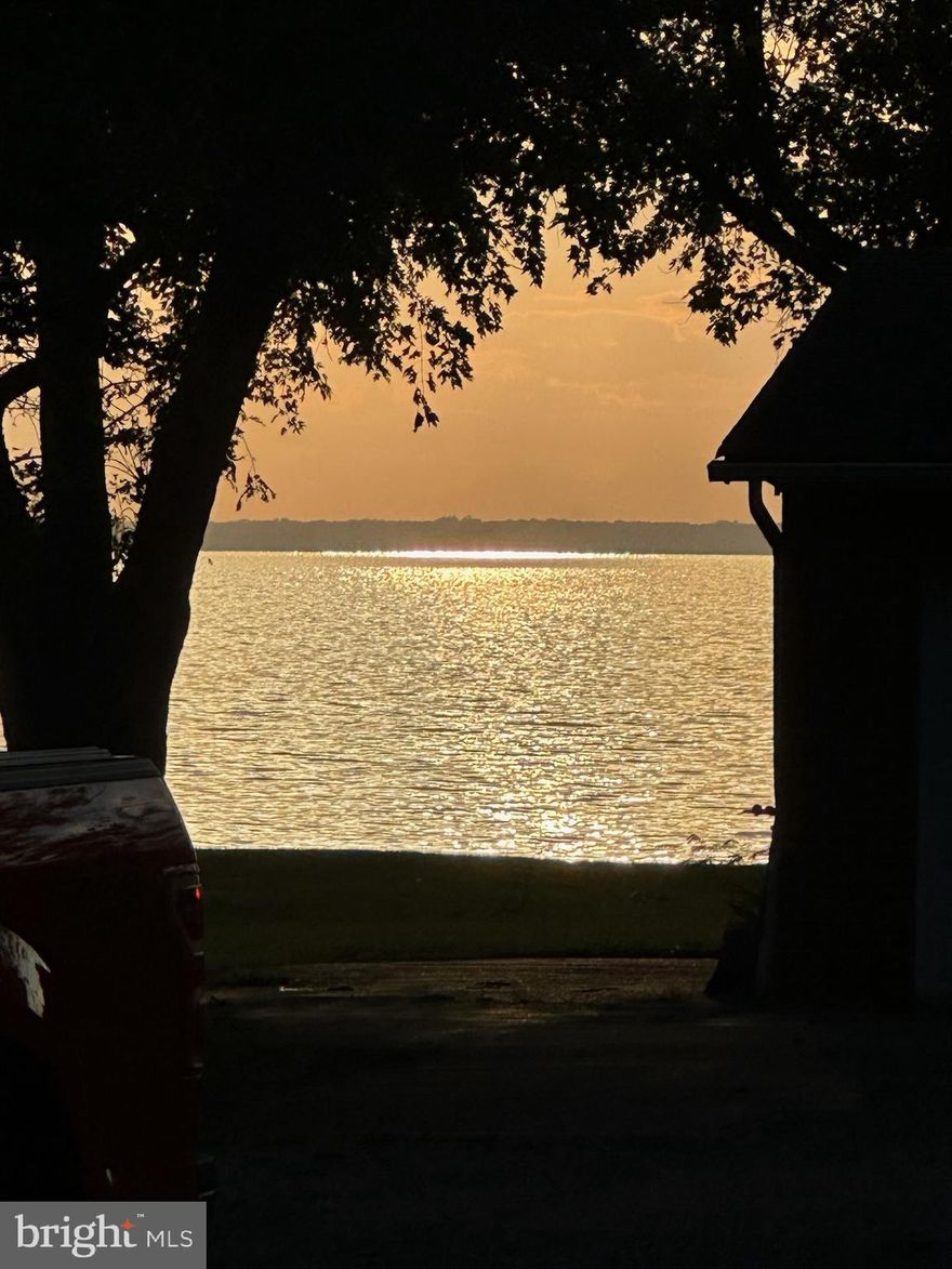 Enjoy your beautiful view of the Bay, serene and relaxing! Whether sitting on the front porch watching the sun set over the bay or in your living room. Even the bedrooms have a view! This beautiful home sits on a large over half acre corner lot, with 2 car garage.
The attic is floored and there is a large shed for your extra storage needs. This amazing 3 bedroom, 2 bath single family home is one level living. The Kitchen has been updated with brand new appliances and granite countertops. The house has just been redone with new flooring, fresh paint and remodeled bathroom. The voluntary community association has gatherings and events for the community to get you connected to your new neighbors and there  is a community beach, a golf course nearby, the romancoke pier with a boat ramp and a walking/bike trail. You will enjoy living the island life! Take a look you will not be disappointed!