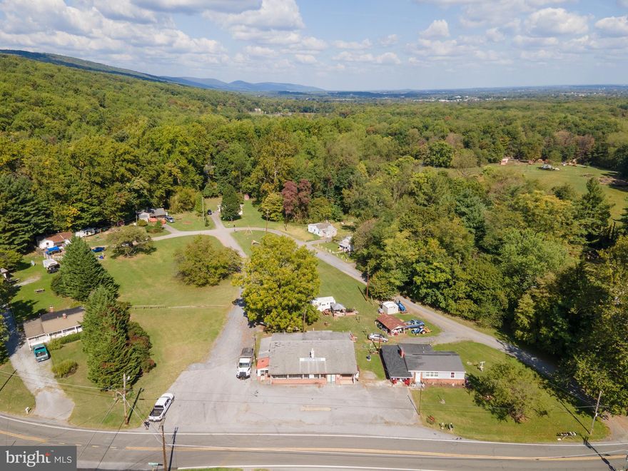 7 units total. 6 single family homes and one commercial unit. Plenty of parking.