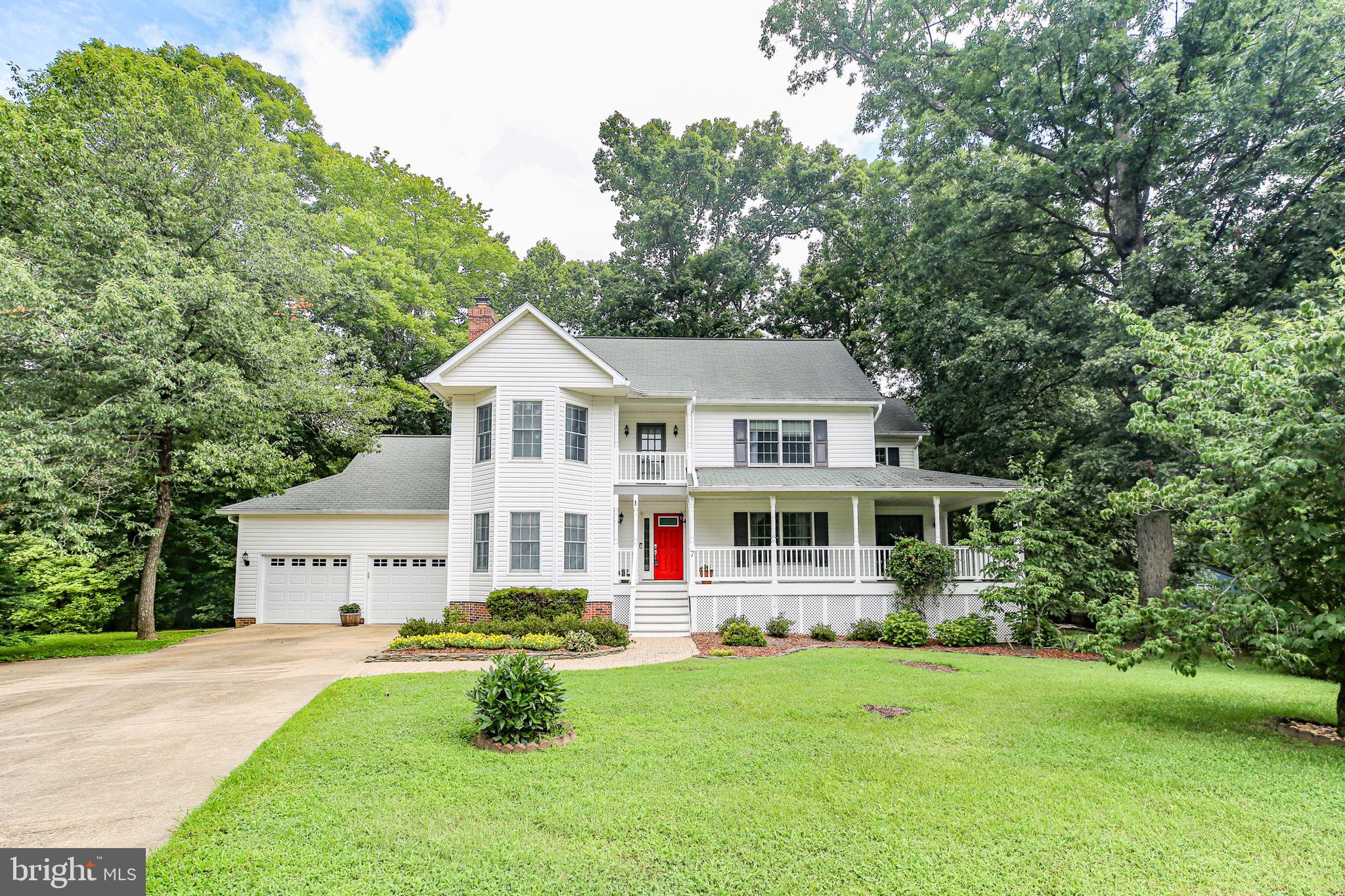Welcome to this picturesque, established neighborhood filled with beautifully built custom homes on large, lush lots—with no HOA! Over one acre to do with what you wish. As you enter the community, you’re greeted by a sense of space, maturity, and privacy. Nestled quietly at the end of a cul-de-sac, this home offers exceptional tranquility and seclusion. The house is strikingly handsome and inviting. Step inside to a welcoming main level featuring gorgeous hardwood flooring throughout and generous living spaces. The formal dining room includes double French doors that open to an extra-large wrap front porch—perfect for entertaining. The updated kitchen offers Corian countertops, a double sink, stainless steel stove and microwave, double oven, maple cabinetry, pantry, and a light-filled eat-in area. The spacious family room features a wood-burning fireplace and sliding glass doors leading to a fully enclosed porch with access to the back deck. A thoughtfully designed floorplan and quality finishes throughout the main level create a warm and inviting atmosphere. Upstairs, the expansive primary suite boasts a three-bay window, walk-in wardrobe, double vanity, and an updated shower/tub combo. Two additional bedrooms, each with classic wood doors and charming details, share an updated full hall bath with a skylight. The fully finished lower level offers incredible flexibility with a massive rec room featuring a floor-to-ceiling brick wood-burning fireplace and mantel, a fourth bedroom with a closet, window, and direct exterior access—ideal for guests or in-laws. You’ll also find a dedicated laundry room with a window and built-in storage, an updated full bathroom, and an additional flex room that could serve as a home office, hobby space, or workout area. Step outside to enjoy the many outdoor living spaces. The oversized front porch is truly the size of an additional room—large enough for a full dining table or lounge setup..Off the family room a large and very tall screened porch with access to the house and large trex deck that backs to trees for complete privacy, and a handy storage shed. The extra-large two-car garage offers ample storage and workspace. This home offers the perfect blend of space, privacy, and character—just minutes from downtown Fredericksburg, major commuting routes, schools, and parks. A rare opportunity in a no-HOA neighborhood! Extra nice neighborhood, extra nice house!