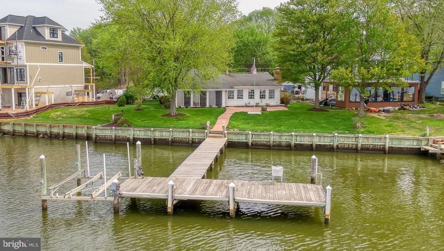 Experience the waterfront lifestyle in this charming 2 bedroom 2 full bathroom rancher with updated kitchen and baths perfectly situated on a large level lot with stunning water views. This property is perfect for water enthusiasts with a private pier that offers easy access for fishing, crabbing or watching the incredible sunsets. Direct access to the water is perfect for kayaking ,paddle boarding, or taking out the boat. Benefit from good mean low water depth providing reliable access for a variety of water craft. The possibilities  for this property are numerous. The larger lot allows for possible future expansion of the house if so desired. The updated kitchen boasts new stainless appliances and granite counter tops. A wood burning fireplace enhances the large living room  and leads into a light filled four season sunroom with incredible views of the water from every direction. A pull down floored attic provides a ton of storage and there is separate shed and workshop for projects and storing kayaks, life vests and water skis etc. This is a very affordable option for a water front life!