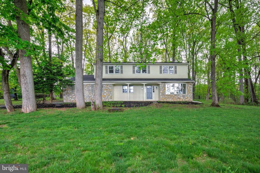 Welcome home to this completely renovated 4-bedroom, 2.5-bath single-family home with an attached two-car garage, ideally located in the highly sought-after Doylestown area. Set back from the road on a partially wooded lot, this property offers both privacy and a beautiful natural setting. Inside, you’ll find hardwood floors throughout and a spacious, flexible floorplan. The main level features a formal living room and an inviting open-concept family room with a stunning stone fireplace, seamlessly flowing into the brand-new kitchen. The kitchen showcases white cabinetry, quartz counters, tile backsplash, stainless steel appliances, and a large center island perfect for meal prep, casual dining, and entertaining. A convenient mudroom off the garage includes laundry and a powder room. Upstairs, three generously sized bedrooms share a full hall bathroom with a tiled tub/shower combination and oversized vanity, while the desirable primary suite offers a spacious retreat with walk-in closet and private bathroom complete with double vanity and walk-in shower. The lower level provides a clean, open basement for practical storage or future finishing potential. Additional updates include a new architectural shingle roof, brand new efficient HVAC, and a passing septic inspection for peace of mind. This turnkey property combines modern updates with timeless style in a serene, natural setting—schedule a showing today!