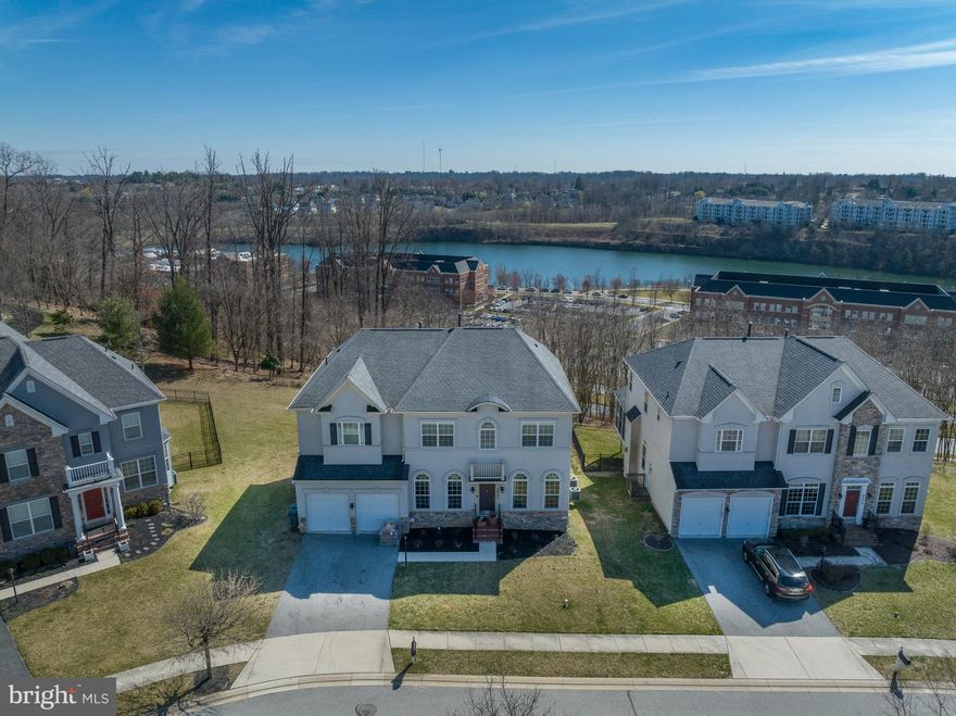 Sleek and stylish home sitting atop the middle of the hill at Quarry Lake has amazing water views from the 1st and 2nd floors! This stunning home is located in a premier gated community with tons of amenities.  As you enter the home you are greeted with gleaming hardwood floors, a curved staircase and medallion ceilings. Columns lead you into the spacious living room with natural light shining through.  Wine and dine guests in the dining room with tray ceilings. The kitchen is an entertainer's dream with plenty of cabinets, tons of prep space, granite countertops, stainless steel appliances, an island with breakfast bar for quick bites, double oven and breakfast nook with views of the Quarry. The kitchen opens to the bright and airy family room with a gas fireplace to cozy up in front of on a cold winter night. Work from home in your office with french doors and coffered ceilings off the foyer.  A beautiful spiral staircase with hardwood flooring and metal balusters leads you upstairs to the spacious primary suite with a custom 3-sided fireplace, room for a sitting area, two walk-in closets and an ensuite bathroom with dual vanities, stand up shower and a large soaking tub to relax in after a long day. There are two additional bedrooms with a Jack and Jill bathroom upstairs and a fourth bedroom with ensuite bathroom, perfect for guests. Upper Level Laundry room with extra storage makes for added convenience. The fully finished lower level rec room is the perfect area to entertain guests for movie or game nights! An additional bedroom and area for an at home exercise room with full bathroom and extra storage finishes out the lower level.  Step outside onto your trex deck off the family room and take in the unobstructed beautiful views of Quarry Lake from your glass rail deck. Amenities include community clubhouse with fitness center, pool, tennis courts, walking or jogging path around Quarry Lake and tons of shopping and dining options at The Shops at Quarry Lake. Don't miss out! Scheduled your showing today!