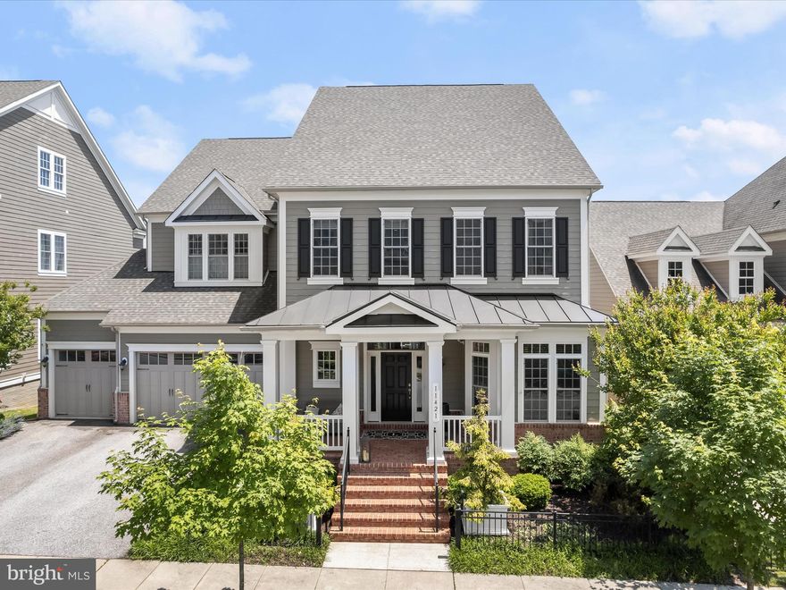 Welcome home to 11421 Dairy Street located in Howard County’s finest community; Maple Lawn. This is a premiere Maple Lawn offering in the most prime neighborhood location and boasts a whopping 9,167 total square feet of lavish living space. Not only is this one of the largest homes in Maple Lawn, but this Garden District stunner features a rarely available MAIN LEVEL BEDROOM SUITE and a coveted 3-car garage. Built by the award-winning Williamsburg Homes, this Hawthorne model has every upgrade imaginable and the jaw-dropping kitchen is worthy of a magazine. The custom stone paver patio, TREX deck, fire pit and water features in the expansive yard back to conservation area and provide unparalleled privacy and outdoor entertaining space.  

The wow factor on the main level immediately impresses with an open-concept foyer featuring soaring 20’ ceilings. There’s a private office located in the front of the home and both the formal living and dining rooms present coffered ceilings. The family room couldn’t be any more inviting or on-trend with its gas fireplace, floating shelves and designer statement wall. The best-in-class chef’s kitchen features grey shaker-style cabinetry, white quartz countertops, 6-burner Wolf range, separate wall oven, Sub-Zero fridge and a beautifully functional farm sink. The mudroom and family welcome center is complete with built-ins which provide the perfect drop-zone upon entering the home. And what truly sets this home apart is the luxe primary bedroom suite also located on the main level, truly making this home one of the crown jewels of the community.

A second primary bedroom suite awaits on the upper level featuring tray ceilings, recessed lighting, a sitting room and two walk-in closets with organizers. The upstairs primary bathroom boasts split vanities with quartz countertops, a garden tub, and a huge shower stall with multiple shower heads. There are two additional secondary bedrooms upstairs which share a bathroom. And the sprawling guest bedroom suite with its own large walk-in closet and full bathroom as well as the laundry room are also located on the upper level. The lower level is in essence a home all its own with its spacious living room, wet bar with full size fridge, separate wine fridge, sink, dishwasher and large eating island. A custom theater room, home gym and full bathroom are also located on the lower level as well as two unfinished rooms for storage or future customization. 

This flagship residence serves as a benchmark of the refined luxury, quality construction, style and taste that’s become synonymous with Howard County’s finest community. Zoned for highly rated Howard County Schools, conveniently located close to all major Baltimore/DC commuter routes, and with enviable amenities including a resort-style community pool, tennis courts, pickleball courts, basketball courts, state-of-the-art gym and more, you’ll quickly see why Maple Lawn is one of the most sought-after communities in the region and why 11421 Dairy Street is truly one of its finest properties.
