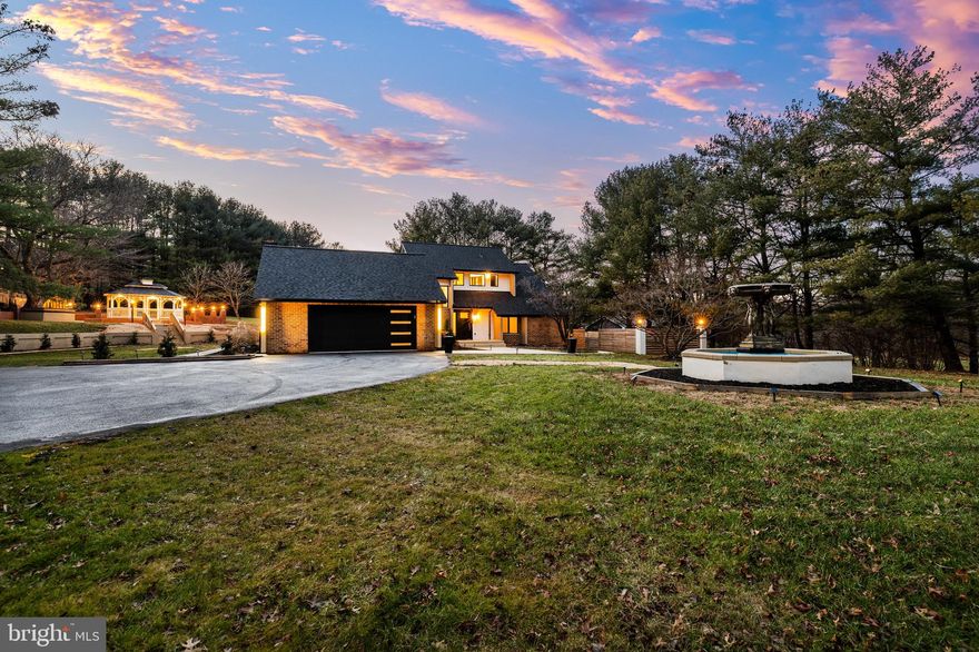 Welcome to 12206 Cleghorn Road, a custom designed spacious contemporary home and rare find in the heart of Cockeysville’s much sought-after Morningside/Laurelford neighborhood.  Tucked in a serene 1.45 acre landscaped lot with mature trees, the home offers the kind of privacy, scale, and elegance that seldom comes to market. With a just completed total renovation, the home includes four bedrooms and four full baths and offers approximately 4700 square feet (including garage) of finished living space with generous sized rooms throughout and a flexible layout ideal for multi generational or modern family living. The main level with expansive gathering areas is perfect for entertaining and features soaring ceilings, large windows, LVP flooring, a great room with wet bar and a built-in library area. The main level’s open flow invites natural light throughout and the sliding glass doors provide seamless access to the expansive 800 sq. ft. composite deck for effortless and harmonious indoor/outdoor activities. The stunning kitchen with vaulted ceilings with exposed beams includes newer top-of-the-line black stainless-steel appliances, including a stainless-steel 48 inch 8-burner gas cooktop (a chef’s dream), high-end wood cabinetry, an island and peninsula with quartz countertops with waterfall edges.  You can choose to dine casually at the vast island with seating for 6 or comfortably in the large breakfast area with a towering wood-burning slate fireplace or breeze through the sliding glass doors to the outdoor kitchen, which includes a grill, sink and a refrigerator, for alfresco dining under the stars. The main level also features the primary bedroom with modern crown molding and an en-suite Carrara marble spa bath for ultimate relaxation, an additional spacious bedroom option, a full bath with stone and glass tile shower and a convenient coat closet. The deluxe laundry room/mudroom complete with smart LG washer & dryer, quartz countertops, shaker cabinets, shelves and a closet with ample storage completes the main level and leads to the two-car garage, which offers a new modern garage door, a large closet and built-in shelving spanning two walls with granite countertops for dedicated storage and workspace.  The lower level features a second kitchen, a full bath, a second laundry area complete with stackable full-size washer & dryer, an exercise room with mirrored walls and floor mat, a quiet office, a large entertaining space and two additional bonus rooms, adding versatility for guests, extended family, children or an opportunity for young adults desiring an independent space. In addition to the large deck that spans the entire length of the house, outside you will find a charming and beautiful gazebo with seating, lighting and a ceiling fan surrounded by a large brick walled patio area and bar creating a peaceful retreat or an intimate entertaining or gathering space. The deep flat back yard offers the future homeowner endless possibilities and the oversized front driveway provides plenty of parking space. Totally renovated, featuring exquisite craftmanship, a new roof (Oct. 2024), new water heaters and water treatment system, updated septic and many more updates. Just minutes from Hunt Valley conveniences, commuter routes, and top rated Baltimore County schools. This is an exceptional opportunity for buyers seeking space, privacy, and a carefree lifestyle in a substantial home in one of the area’s most desirable luxury corridors.