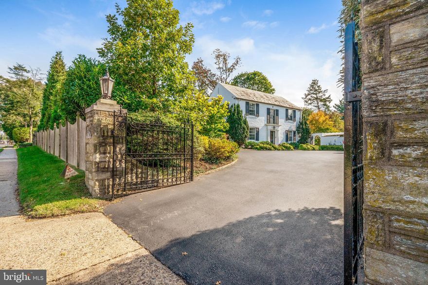 A true gem! This Classic Colonial Revival is situated on a double lot on over 2/3 of an acre of private walled grounds with beautiful specimen plantings and perennial gardens, all just steps from the top of the hill in the heart of Chestnut Hill. Upon entering this five-bedroom, five full bath home you are immediately struck by the lovely entry hall with beautiful checked marble floor and original curved stair case with iron railing that opens into an inviting receiving room, both the center of this impeccably designed property. This exceptional flow is perfect for entertaining, with access to the dining room and living room off of the entry hall. The large living room with fireplace, custom built-ins and alcove has a bay window overlooking the exceptional grounds. The warm dining room with built-ins opens into a large eat-in kitchen. The sunlit kitchen is truly the central heartbeat of the home and perfect for all the needs of today's discerning buyer with custom cabinetry, oversized island, breakfast room, sitting room area with built-in desk, powder room, back stair and access to laundry room and mudroom. The first floor also includes a family room with wet bar and sliders to the rear terrace and plunge pool. There is a separate wing with private back office, a greenhouse that doubles as potting shed, and interior access to the garage. Ascend the architectural staircase to the second floor and to the right you will find the renovated owners suite with dressing room, walk-in closets, marble bath with radiant floors and two vanities, all overlooking the exceptional grounds. Two additional bedrooms, each with ample closet space, a renovated hall bath and third bedroom suite with bath round out the main portion of the second floor. As you walk through the fourth bedroom, you access the in-law/au pair suite with additional storage space, bedroom, full bath and private stairs to the first floor. This serene property is impeccably maintained with mature landscaping, multiple exterior terraces and sitting areas, and exterior architectural garden features. Two car garage, two tankless water heaters, multi zone HVAC and much more. All in an exceptional 'walk-to' location, with easy Top of the Hill, Regional Rail and park access, this is an impeccably cared for home - a true oasis on the Avenue.