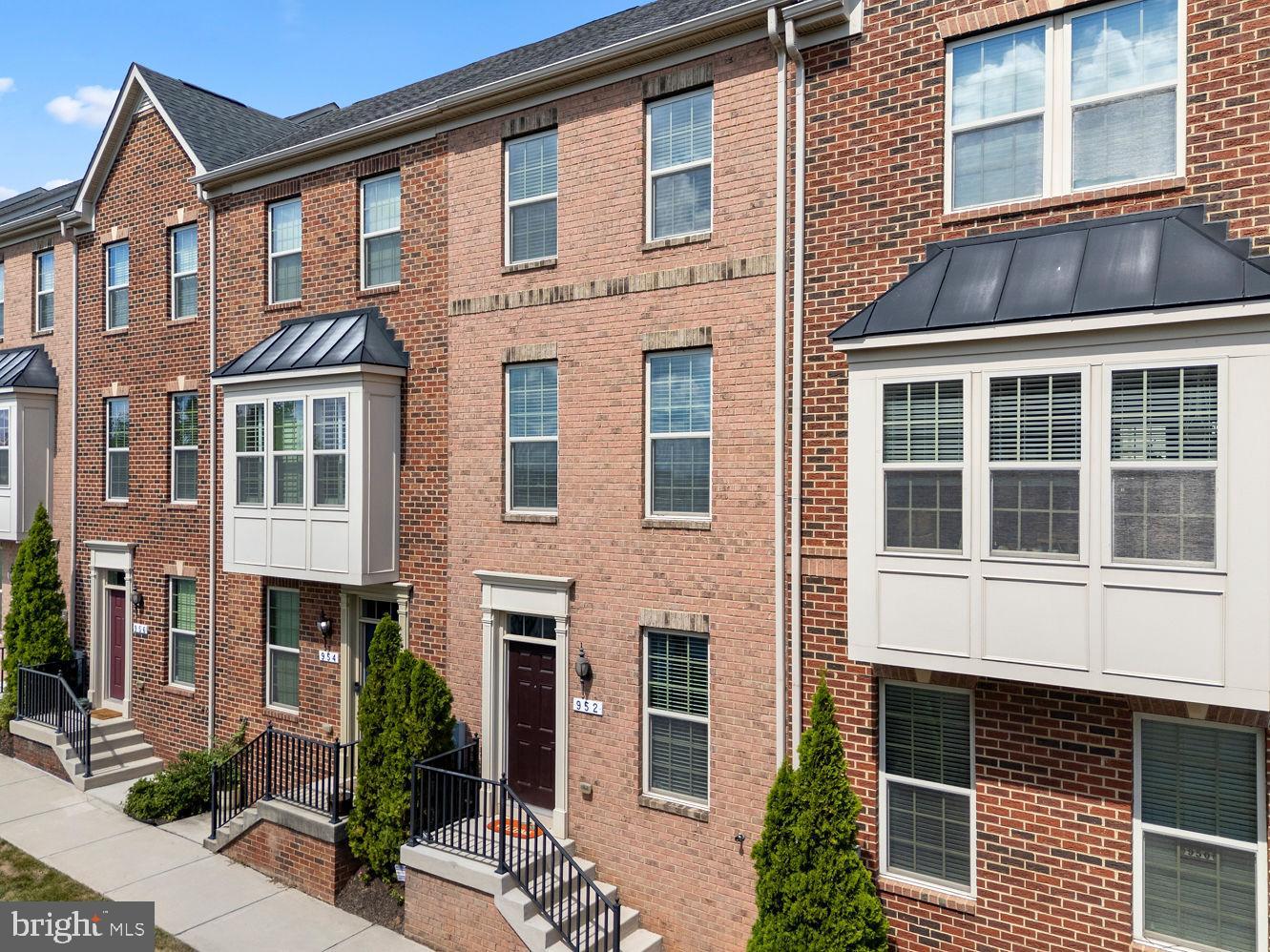 Welcome to O'Donnell Square! This 2-bedroom, 2.5-bath Colonial-style rowhome offers three finished levels and 1,376 square feet of thoughtfully designed living space. The open main level features a bright living area and a well-appointed kitchen with stainless steel appliances, a center island, and a breakfast bar perfectly situated between the kitchen and living space. There’s also room for a table in the kitchen, giving you flexible dining options. From here, step directly out to the rear deck—a great spot for relaxing, entertaining, or enjoying fresh air right off the main level. Upstairs, two spacious bedrooms each have access to full bathrooms, including a private en suite in the primary. The finished lower level provides additional versatility with a family room, walkout access, and interior entry to the attached garage. A concrete driveway adds extra parking convenience. Set within the sought-after O'Donnell Square community, this home offers easy access to local shops, dining, and nearby Canton attractions while still tucked into a welcoming neighborhood setting.