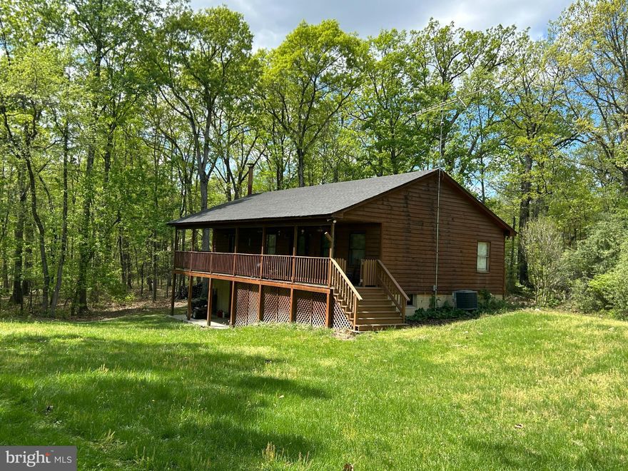 Experience the best of country living with modern comforts. Your dream retreat situated in the heart of nature; whether you seek a vacation getaway or a permanent paradise, this property is your perfect match!  This charming cedar ranch offers 2+ acres of land, framed by majestic mountains and a serene river, creating the perfect escape. New roof, New well and freshly painted interior makes this home ready to move in and enjoy. Huge primary bedroom with private bath, nice sized closet and access to porch. Kitchen has plenty of cabinet space and natural light. Beautiful hardwood floors. Fabulous porch running the full length of the home is excellent for that morning coffee or relaxing with a good book. Separate mud/laundry room. Full unfinished walk-out basement with woodstove and a secure locking storage room. Convenient commuter location and about a mile from a public Shenandoah River access point. Close to National and State Parks, Skyline Drive and the Appalachian Trail – Perfect for Hiking, Wildlife & Endless Outdoor Adventures.