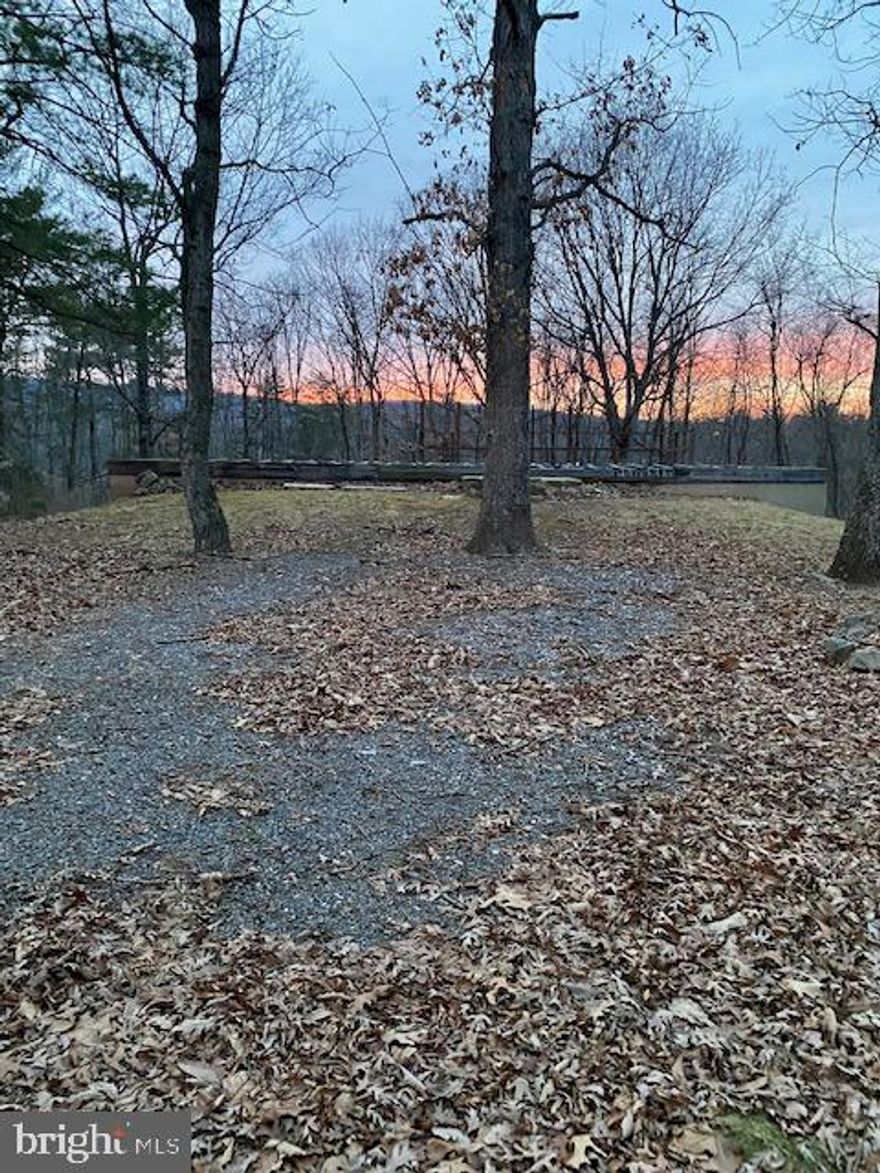 IF YOUR LOOKING FOR A PLACE TO BUILD IN THE FUTURE OR A WEEKEND GETAWAY SPOT RIGHT NOW, YOU OWE IT TO YOURSELF TO CHECK OUT THIS PROPERTY WITH A FULL FOUNDATION, WELL, SEPTIC & ELECTRIC ALREADY IN PLACE. IF YOU WHERE TO REMOVE SOME TREES IN THE REAR  OF THE PROPERTY IMAGINE THE VIEW OF THE MOUNTAIN IN THE BACKGROUND YOU WOULD HAVE TO ENJOY. THIS LAND IS APPROXIMATELY 1 & 1/2 TO 2 HOURS FROM WASHINGTON DC & BALTIMORE MD. GET BACK TO NATURE AND SOME PEACE & QUIET & TAKE A BREAK FROM THIS FAST PACED WORLD AND LET THIS PROPERTY BE YOUR PERSONAL RETREAT. YOU COULD PARK A CAMPER OR TRAVEL TRAILER ON THE PROPERTY UNTIL YOU ARE READY TO BUILD. THE FOUNDATION IS IDEAL FOR A MODULAR HOME OR STICK BUILT HOME. IT'S CONVENIENTLY LOCATED WITH EASY COMMUTING TO WORK OR SHOPPING. ABOUT 10 MINUTES FROM HISTORIC BERKELEY SPRINGS WV WITH ITS QUAINT SHOPS & RESTAURANTS. ABOUT A 30 MINUTE DRIVE TO HANCOCK MD WITH THE POTOMAC RIVER, C&O CANAL & WESTERN MD BIKE PATH.