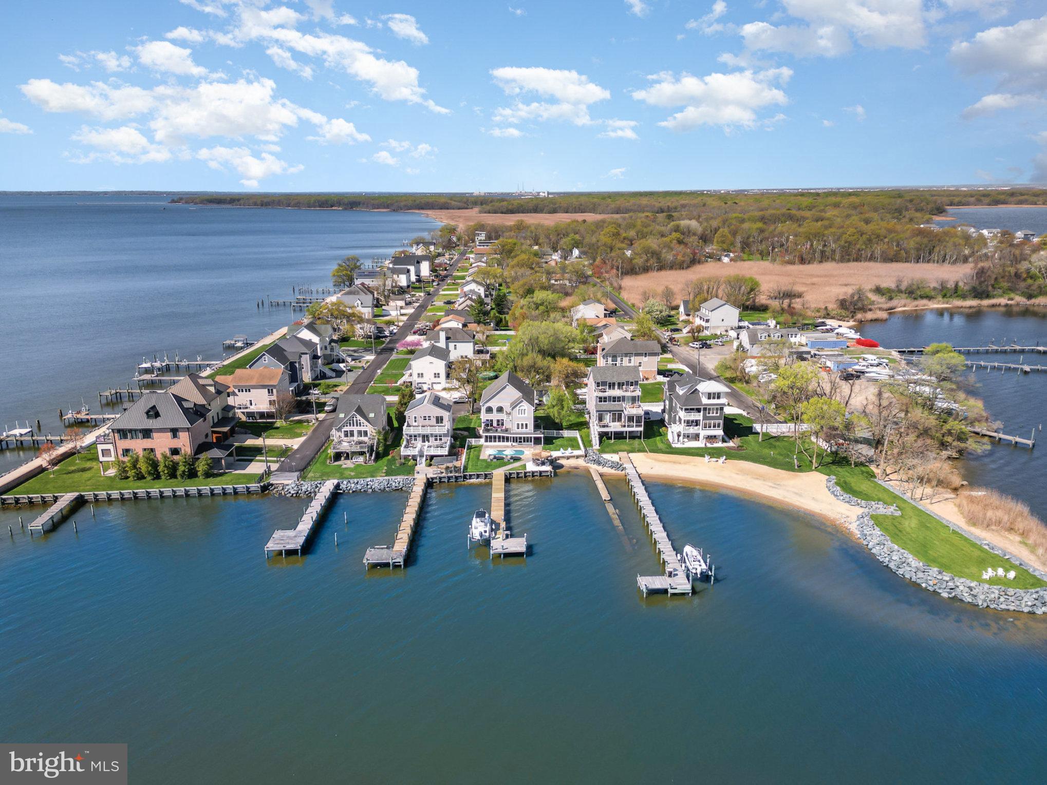9110 Chesapeake Ave Millers Island MD is being offered for the very first time since being built in 2001. Experience Chesapeake Bay Prime Waterfront Living at its finest but only minutes away from all points Baltimore County and City! This is your chance to act quickly for a Two Million Dollar Waterfront View and Location for just under 1.4 Million. If you love to entertain, this ultra cool 84 FT WIDE waterfront location is made for you. If you prefer peaceful solitude, it’s perfect for that, too. Nestled along the shores of Millers Island/Hawk Cove, this magical Baltimore County point offers breathtaking views of sunrises, moonrises, and the majestic 105ft tall Craighill Lighthouse. (Tallest Lighthouse in MD) Watch all shapes and sized underway boats glide by, paddle boarders and kayakers swiftly cruise the shorelines, or marvel at kite surfers catching the bay breeze—all from your own backyard, pool, deck or pier. The outdoor amenities are second to none: a built-in 12' x 24' pool, a 100-foot pier with an electric boat lift, and a 10' x 34' screened porch for bug-free evenings. Relax on the main level maintenance-free composite deck with pipe rail systems or gather around the outdoor Tiki Bar and Grilling Station for unforgettable cookouts, televised sporting events or parties. With direct beach and water access, you’ll enjoy easy entry for swimming, wading, paddling, waterfowl hunting or hopping on and off your personal watercraft. Big Plus, Plus, this spot is a haven for fishing and crabbing enthusiasts of all ages. The home, built in 2001, offers an open-concept floor plan with expansive Chesapeake Bay views from the family room, kitchen, breakfast nook, primary bedroom, and guest bedroom. The main and lower levels feature newly installed quartz counters, stylish new stainless Samsung appliances, and updated HVAC for modern comfort. With 5 bedrooms, 4 full renovated baths, and a dedicated office/den, this home offers flexibility for every lifestyle. Both the main and lower levels have their own laundry rooms for added convenience. The ground-level finished area presents endless possibilities—it features a full kitchen, a second full-size laundry, a spacious living area, 1 bedroom, and 1 full bath. Utilize it as an Airbnb income, in-law suite, au pair quarters, guest retreat, or private getaway for a high schooler or college-aged child. Conveniently located, this prime spot offers easy access north to Middle River and Gunpowder, south to Annapolis and the Bay Bridge, east to Rock Hall and Tolchester, and westward into the Patapsco River and Baltimore Harbor. Whether you’re hosting lively gatherings or savoring peaceful moments, this waterfront sanctuary offers a lifestyle that is truly one of a kind.