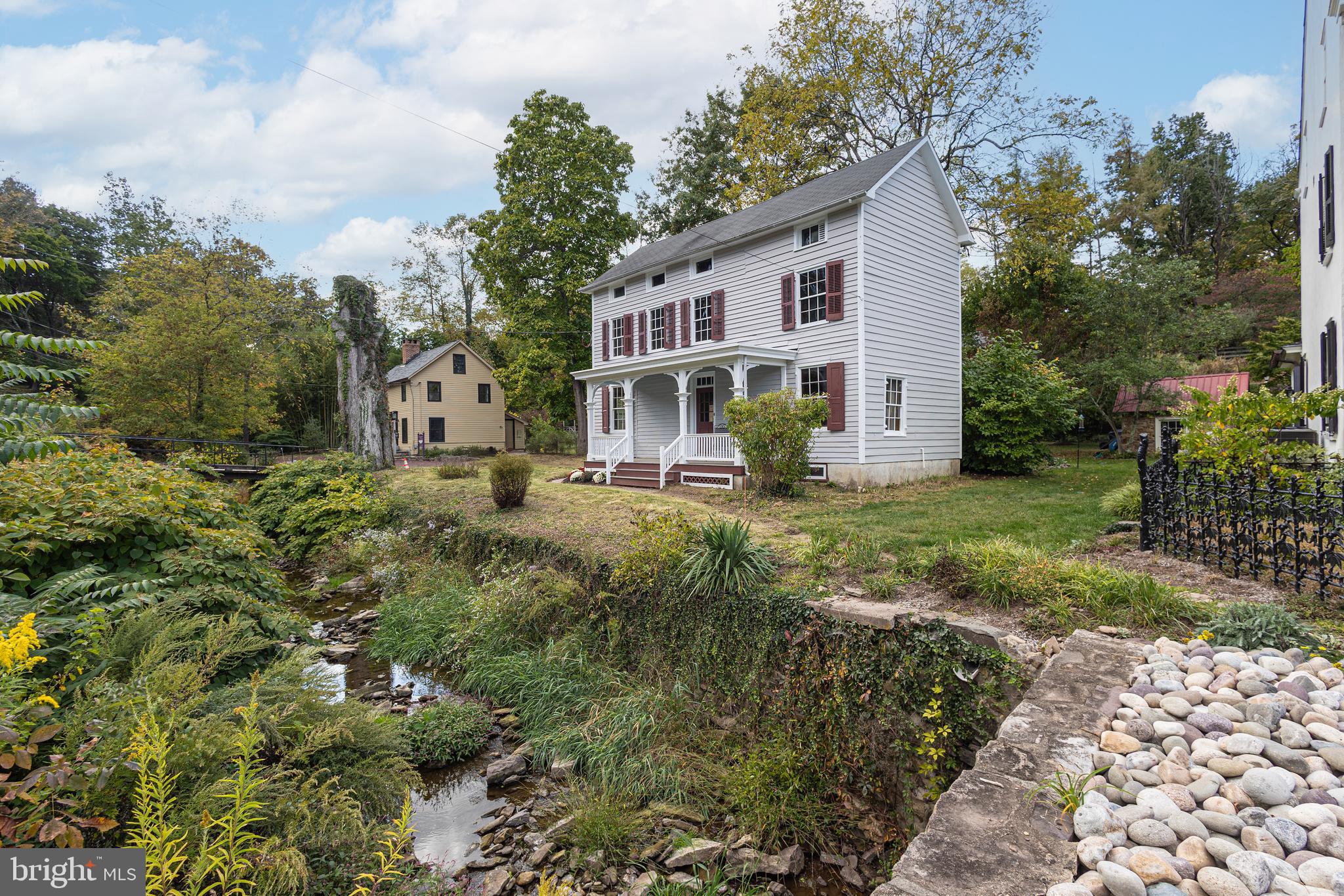 Discover the charm of historic Carversville with this beautifully restored c. 1865 Bucks County farmhouse. Situated just across the stone bridge over the Paunacussing Creek, this home combines period charm with modern convenience and is just steps from the newly updated Carversville Inn & General Store.
Step onto the inviting front porch and take in the peaceful surroundings. Inside, the home showcases original craftsmanship with wide plank floors, classic plaster walls, and thoughtful updates throughout. The chef's kitchen is a highlight, featuring stainless steel appliances, leathered quartz countertops, a breakfast bar, and handmade terra-cotta floors with radiant heat. Sliding glass doors in the eat-in area offer picturesque views of the lush landscape. Interior photos soon to come.
This spacious home includes three bedrooms and two and a half bathrooms, providing plenty of room for comfortable living. The second-floor laundry area with washer/dryer hookups adds convenience. Located in the sought-after Carversville Village, you’ll enjoy proximity to the shopping, dining, and entertainment of Doylestown and New Hope, with New York City just 90 minutes away.
Embrace the perfect blend of historic elegance and modern comfort in this unique Bucks County residence.