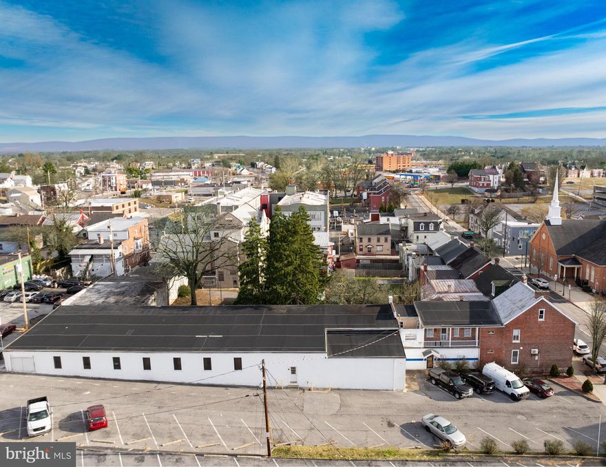 Rare opportunity to lease a spacious 6,000 SF commercial warehouse/retail/flex property in a prime downtown Hagerstown location. Located at 132 E Washington St, this highly visible property offers approximately 1,000 SF of office space and 5,000 SF of warehouse space, providing an ideal layout for a wide range of business uses. The building features high ceilings and an open, functional configuration suitable for contractors, light industrial users, retail operations, storage, hardware stores, or mixed-use businesses. Formerly home to Fridinger-Ritchie Plumbing and Heating, one of the oldest and most well-known companies in Washington County, the property carries a strong commercial legacy. Its size, flexibility, and central location in the heart of Hagerstown make this a truly rare and valuable space for established or growing businesses seeking a prominent and adaptable commercial footprint.