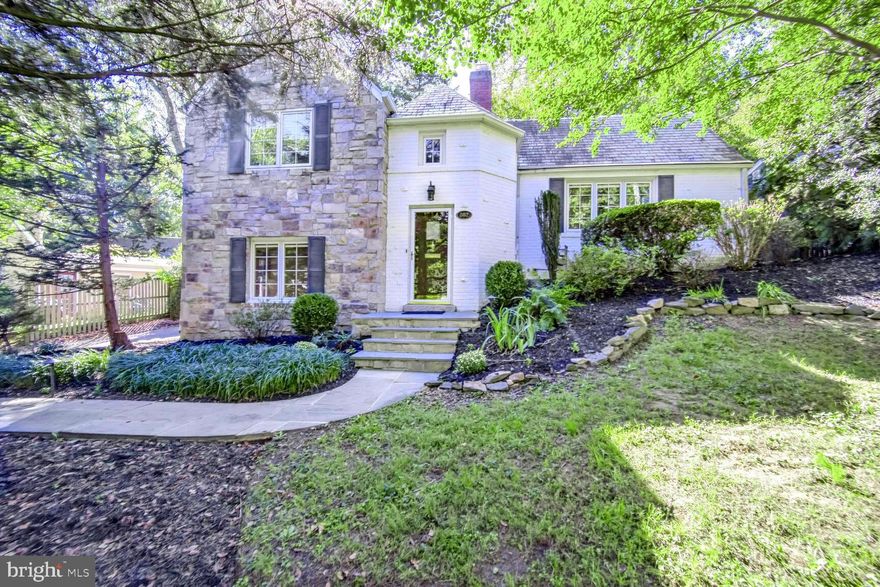 Discover a storybook Tudor brimming with charm, character, and modern updates in the heart of Silver Spring! Nestled on a nearly quarter-acre lot in South Woodside Park, this architectural gem offers a unique blend of classic details and contemporary comforts.
From the moment you step into the soaring entry hall with its flagstone floor and overhead turret, you’ll be captivated by the thoughtful design that unfolds across three levels. The bright, vaulted living area boasts exposed beams, gleaming hardwood floors, and an oversized wood-burning fireplace flanked by arched doorways, leading to a sun-drenched Florida room overlooking the serene rear gardens.
The newly renovated kitchen features quartz counters,  plenty of cabinet space, a Bosch stove, and LED under-cabinet lighting. Adjacent, the large dining room is ready for your next dinner party, while the main level spa-like bath, complete with radiant floor heating, travertine tile, and a jacuzzi tub, adds a touch of luxury.
Upstairs, the expansive primary suite offers versatility, with double closets, room for a home office, and access to a private screened porch and deck. A second upper-level bedroom with an adjacent closet/playroom inside the turret adds whimsical charm. Outdoors, the park-like setting is truly a retreat, with mature landscaping, dry-stacked stone walls, and flagstone paths.
Modern conveniences include a high-efficiency Navien boiler and tankless water heater, 2023 exterior drainage upgrades, and a tandem two-car garage. With its proximity to Sligo Creek Park, downtown Silver Spring, Whole Foods, metro access, and major commuter routes, this home is ideally located for work, school and play!
