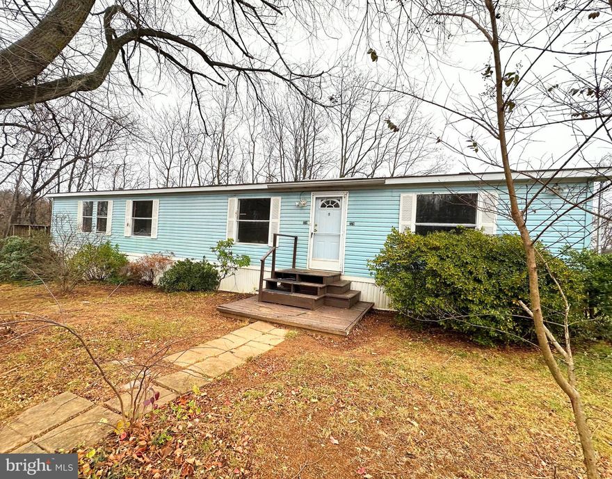 PRICE REDUCED! This 3 bedroom, 2 bath double wide home is one of the largest homes in the community.  It has a lot of potential. It is located in the peaceful gated Rocky Glen Mobile Home Community and  sits on the large corner lot with nice view.  2 sheds offer plenty of storage: front shed 12x8, shed in the back is huge 12x24. Generous deck 17x12. Being sold As Is. 
As you enter, you'll be welcomed by a large living room with vaulted ceiling and wood burning fire place.  Open floor plan reveals a large bright kitchen-dining combo, with nice size pantry. The laundry room is conveniently located next to the kitchen and takes you to the deck.  The generously sized primary bedroom features a private full bathroom, while two additional spacious bedrooms share a main bath and located on the other side of this home. Can be your primary residence or an investment. 
Must be approved by the park. Cash Only or submit offer with pre-approval letter from the lender.
 Lot rent is $450.  Let's make a deal! Schedule your showing today!