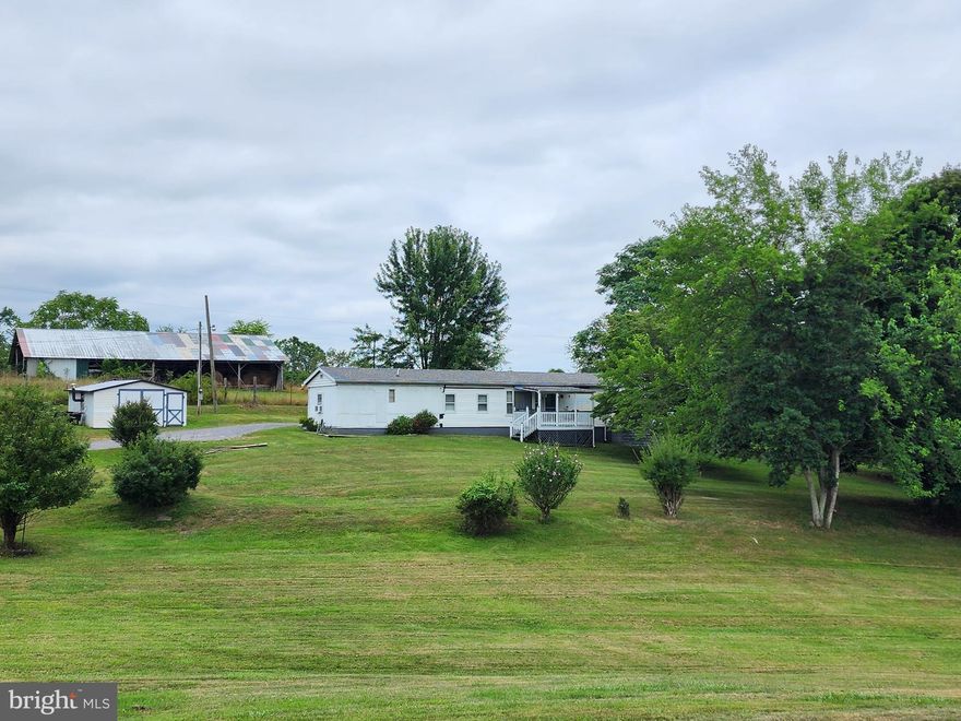 Single-wide featuring 3 bedrooms and 1 bath, with dining room addition, situated on just under an acre of land (.95 acre).  Property includes small storage shed, additional garage/shed, back porch, and charming front porch with views of the spacious yard.  Property is approximately 15 minutes from downtown Berkeley Springs (Town of Bath).