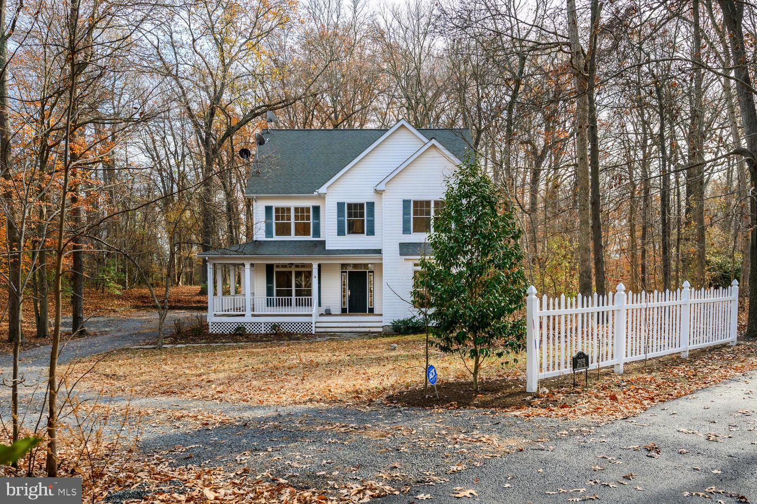 Nestled at the end of a serene wooded street, this beautiful Colonial-style home offers comfort and privacy. The spacious 2,380 sq. ft. residence offers hardwood floors throughout, four generously sized bedrooms, and two and a half bathrooms. The inviting living area boasts a cozy gas fireplace and blends seamlessly into the kitchen with center island. Located in a tranquil rural setting, this home offers the perfect escape from the hustle and bustle of life while still within reach of local amenities. Embrace the charm of private country living with the convenience of modern amenities in this exceptional property.