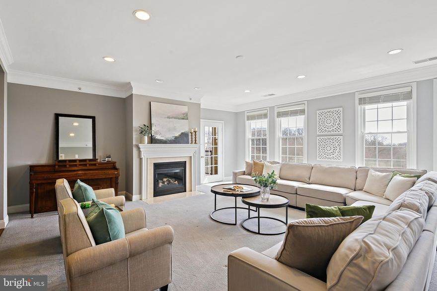 OFFER DEADLINE!  All offers due by Sunday, March 23rd at 6:00 PM!  Discover luxury living at 701 Fallsgrove Drive. As you enter this rarely available penthouse corner unit with park views throughout, the inviting foyer greets you with a tray ceiling, deep crown molding, and gleaming hardwood floors, setting the tone for the expansive interior. The living room, with gas fireplace, soft carpeted flooring, and recessed lighting, provides a warm and inviting atmosphere with access to the balcony, perfect for morning coffee. The adjacent formal dining room, featuring crown molding and chair rail, is perfect for hosting elegant dinner parties. The well-appointed kitchen features upgraded countertops, stainless steel appliances, electric cooking, a convection/microwave, maple cabinetry, a pantry, and an island for additional prep space, all enhanced by a tile backsplash and tile flooring. The bright family room and breakfast room, with hardwood flooring and access to another balcony, ideal for casual gatherings. The laundry room, conveniently located near the elevator, doubles as a secondary entrance, making grocery deliveries a breeze. Bedroom 3, and a full bath, is perfect for a guest suite or au pair living arrangement. Make your way back to the foyer, you'll find a half bath for guests. Continue down the bright hallway to find a home office, Bedroom 2, and another full bath. The primary bedroom suite is a luxurious retreat, featuring two spacious walk-in closets, a linen closet, new plush carpeting, and elegant crown molding. The primary bath offers relaxation and comfort with double doors entry, tile flooring, separate soaking tub, walk-in shower with a beautiful tile surround, and a large double vanity. The Fallsgrove Community boasts sought-after amenities, including a community pool, clubhouse with fitness and meeting rooms, and walking and jogging paths. This beautiful home includes plenty of storage and parking for three vehicles, with two deeded single car garages, a single covered carport, and an additional storage unit inside the building. With nearby shopping at Fallsgrove Village Center and easy access to commuter routes, this property provides convenience and luxury. Schedule your private tour today and experience the best of Fallsgrove living!