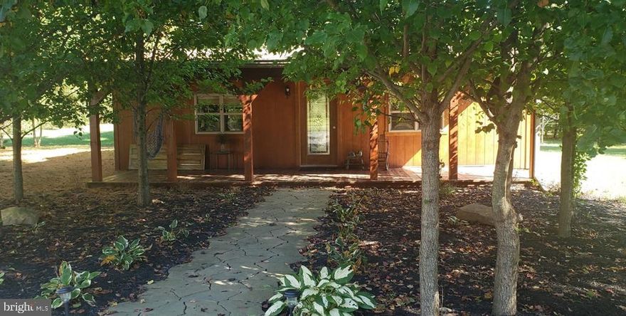 Peaceful cabin nestled among blooming pear trees on the edge of Fayette Township !! 3.088 acres of wildlife and seclusion but only a 5 min drive from 322. Built in 2015, this cabin features a fully equipped country kitchen with island & plenty of loft space for storage or sleeping (for kids or those young at heart!) Mini split and electric fireplace keep you comfy. Master bedroom, full bath and laundry room. All appliances stay !! Relax around a fire out back, take a dip in the above ground pool or get lost in a hammock on the covered front porch. Used as a Seasonal Residence. Selling As-Is. Enjoy the cabin getaway OR build your dream home & connect to the existing well/sand mound/400 AMP electric service.