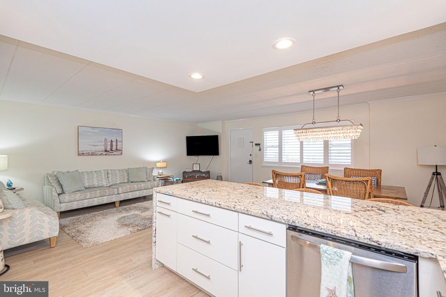 Well this condo is SPECTACULAR!!!!! Move in and walk to the beach OR are you looking for a great rental income....35k a year and bookings already for the summer of 2026 and can be transferred if you wish.  The building is so well maintained, the condo has been fully renovated and is just beautiful.   As you walk up to the second level you are greeted with a large balcony that can host the family to sit outside and take in the salt air.   Once you open that door, you are WOWED!!!! ...large open concept family room, breathtaking kitchen with a waterfall granite countertops, backsplash, stainless steel appliances and LVP flooring throughout and large eating area with an amazing focal point chandelier.  .  The 2 large bedrooms have updated full bathrooms (main bathroom updated 2025) .... the list continues with plantation shutters, recessed lighting, newer HVAC...My favorite feature is the location...... North Ocean City, Southern Exposure with a great oversized balcony and a very strong involved condo association (great parking) Let the Spring and Summer begin.....Reserve study has only 3 qtrs left of $475.00.....this is the one!!!
