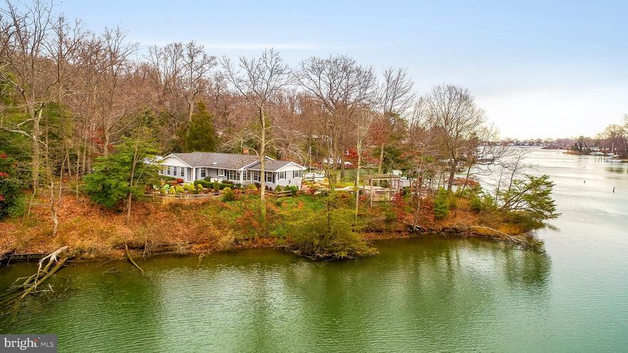 Panoramic water views with approx. 395 ft of water-frontage, heated waterfront pool, and easy access to your deep water protected pier! Elegant raised ranch sited on a well landscaped lot with waterfront patio.  Fabulous condition with over $150,000 in recent UPGRADES includes a gourmet kitchen with top of the line Viking and SS appliances, grand Master Bedroom/Bath suite, Private Office, and fully finished Lower Level.  High vaulted and cathedral ceilings, cozy wood burning fireplace, hardwood floors, and spectacular water views from most rooms!  Over 2860 Sq Feet of finished space.  Attached 2-Car Garage and ample parking to accommodate guests. Great for entertaining or intimate gatherings. Lovely community with amenities that include beach, boat ramp, common grounds, and picnic area.