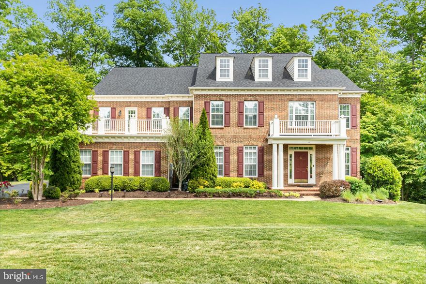 Situated on a spacious 1-acre lot in the prestigious Battleground Community within Celebrate this magnificent colonial offers 4 bedrooms, four baths and elegant spaces for living, relaxing and entertaining. Spread over three floors, enjoy over 6,700 square feet of luxurious living space.  As you approach a full brick front with a charming  covered entry welcomes you home.  Inside, the bright open concept living promotes a pleasing ambiance boasting refined tray ceilings and shining hardwood floors with fine fixtures and high end finishes throughout.  Every chef will love the true gourmet kitchen, complete with premium stainless-steel appliances including a gas cooktop, double oven, and newer refrigerator.  Plenty of cabinet storage and counter space plus a fabulous island make entertaining a pleasure.  Gather for a casual meal in the delightful adjoining breakfast space while taking in scenic yard views.  Beyond, a grand  family room with 2 story high ceilings,  two sided fireplace call on you to relax.  Work is a pleasure from your private office.  Relaxing is even easier from the large sunroom overlooking the tree lined yard.  Also, find an elegant formal living and large formal dining room, perfect for a large party or an intimate gathering.  A picture of luxury, the tranquil second-floor primary suite is a wonderful retreat with its own private balcony.  Oversized walk-in closet and spa style bath.  Three additional large bedrooms are also on this level with additional two full bathrooms.  Second back staircase makes access even easier for younger children.  Even more amazing space for entertaining is found on the basement level.  The finished basement is an entertainers dream.  Settle in to watch a movie in the custom theatre room.  110 inch screen and surround sound convey.  Get your gym on in your own private space or could be lower level room NTC.   Recreation room with custom wet bar with pool table and game space.  Additional den/sitting area for gatherings.  There is still a utility space with excellent storage and full bath.  Walkout basement leads to a concrete patio area and private tree line overlooking a creek.  Simply unwind on one the deck or the lovely patio.  The spacious lawn beyond is perfect for children to play and pets to roam.  Large attached three-car garage with plenty of overflow parking.  75 gallon water heater 2020.  HVAC system installed 2018.  New roof 2018.  Fridge 2019