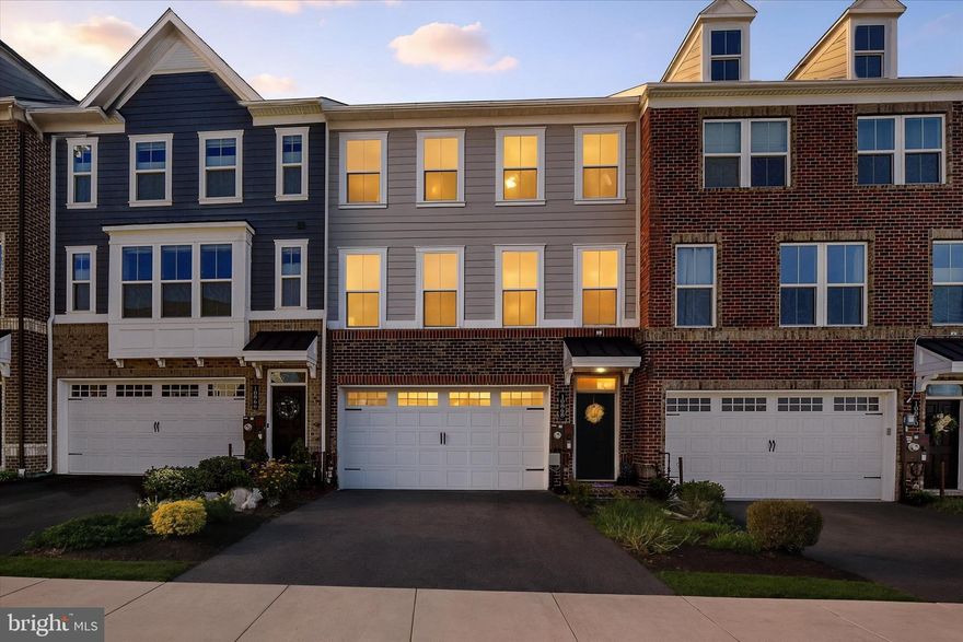 Welcome to 10868 Beckenham St. located in the vibrant community of Greenleigh at Crossroads, where this stunning 4-year-old craftsman townhouse awaits its new owner. This home offers an exceptional living experience with a focus on modern design and community amenities. It spans four levels, offering ample space and flexibility for today's lifestyle needs. Start with the ground level, which features a spacious two-car finished garage with an epoxy floor, ensuring durability and easy maintenance. The foyer, arrival center & recreation room greets you on this level, perfect for casual lounging or entertaining guests, with a convenient full bathroom and direct access to a private backyard. As you ascend to the main level, a gourmet kitchen becomes the centerpiece of this home. It features a 10-foot island topped with elegant granite countertops, complemented by pendant lighting that adds a touch of sophistication. The kitchen is equipped with a double wall oven, cooktop, and a stainless-steel farmhouse sink nestled among timeless white 42" cabinets with a stylish subway tile backsplash. Adjoining the kitchen is the open dining area that seamlessly connects to an 8' x 21' balcony, complete with an outdoor gas fireplace with stone mantle and a weatherproof TV, perfect for alfresco dining and entertainment. The main level also boasts a great room with a beautiful framed 55" wall mounted TV, custom lighting & blinds, providing a perfect setting for relaxation and family gatherings. The LVP flooring adds a touch of elegance while ensuring practicality against everyday wear. A half bath on this level ensures convenience for residents and guests alike. Heading to the upper level, the primary suite is a serene retreat featuring a walk-in closet and an ensuite bath. The bathroom is designed with natural light, double vanities topped with granite and a frameless, hand-built ceramic walk-in shower. Two additional spacious bedrooms and another full bath with double vanities and laundry room complete this level, offering ample space for family or guests. The fourth level features a loft area, perfect for a home office or guest suite. It includes a bedroom and a full bathroom with a walk-in shower. A captivating highlight of this level is the loft and 13' x 22' rooftop deck, offering panoramic views and a peaceful outdoor escape. The 2-stage heating & air systems assures comfort on every level.  Living in Greenleigh at Crossroads means you are part of a vibrant community with access to walking trails, tot lots, a dog park, and a community center that houses an outdoor pool and fitness center. This property’s location is ideal for those who value community living while appreciating modern convenience, with quick access to shopping, dining, and commute on all major roadways leading to Baltimore, D.C., and Delaware. This property is perfect for buyers seeking a contemporary home within a thriving community that offers both convenience and a sense of belonging. To schedule a viewing, please get in touch. I'm here to assist you with any inquiries and guide you through the process of making this exceptional residence your new home.