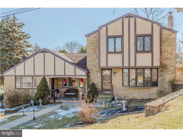 Enter this tudor style home through the front door into a formal living room which has a beautifully hand tiled ceramic floor and is complimented by the stone wood burning fireplace.  Tons of sunlight pours through the giant bow window in the formal living room.  Up the staircase to your left there are 3 bedrooms, the master bedroom with a master bathroom, two other bedrooms and a shared bathroom with a laundry chute emptying into the laundry room.  Back downstairs in the formal living room there are two brick archways leading to the formal dining room.  Two elongated windows allow optimal sunlight in here also.  Leaving the dining room, there is a laundry/mud room complete with the laundry chute closet, a new linoleum tile floor (2015), utility tub, and a door that exits to the back patio.  Three steps down leads to the kitchen, breakfast room and family room. These rooms have an open concept.  The family room has a door from a small porch to the outside which was the original main entrance when the house was a ranch home before the owners added an addition. To the right of the family room, there is a long hallway leading to a full bathroom, two other bedrooms, and an office with built-in book cases.  The office has sliding glass doors leading to a 22 x 12 foot patio, a spacious, fenced backyard and an above ground pool.  In the basement there is a sprawling recreation room complete with a powder room and a bar with cabinets - great for entertaining.  There is also a large unfinished area which has storage, furnace, hot water heater, double utility tub, etc.  The basement has an exit to outside.  Don't lose your opportunity to move into the best that Bala Cynwyd has to offer.  This giant 4800 square foot home has so many options.  This home has the potential of 5 or 6 bedrooms.  Just use your imagination- there is the possibility of an in-law suite.   Move into this unique suburban home close to everything, Main Street Manayunk and the entrance to 76 is less than a mile away.  Lower Merion School District and no city wage tax.  Great community in beautiful Belmont Hills!