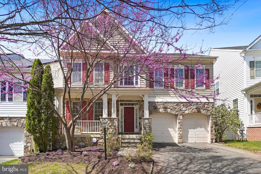 Welcome to 12333 Cherry Branch Drive, a stunning residence nestled in the vibrant and highly sought-after Clarksburg community. Boasting over 5,500 square feet of beautifully finished living space across three levels, this exceptional home backs to a serene conservation area, offering both privacy and picturesque views.

Step onto the inviting front porch and into a grand two-story foyer that sets the tone for the elegance found throughout. The main level features gleaming hardwood floors and an abundance of natural light streaming through expansive windows. Formal living and dining rooms showcase refined details, including crown molding and a tray ceiling. The space is perfect for hosting memorable gatherings.

At the heart of the home, the gourmet eat-in kitchen is equipped with custom cabinetry, a butler’s pantry, stainless steel appliances including a double oven and gas cooktop, and a tiered island with breakfast bar seating. The adjacent dining area opens seamlessly to a stunning enclosed porch with a vaulted ceiling and tranquil views of the mature tree line, with direct access to the outdoor deck ideal for indoor-outdoor living.

The kitchen flows effortlessly into a dramatic two-story family room, highlighted by a floor-to-ceiling stone fireplace and atrium windows that flood the space with light. A private home office, powder room, and mudroom with garage access complete the main level.

Upstairs, the spacious bedroom level offers four generously sized bedrooms and three full bathrooms. The luxurious primary suite is a true retreat, featuring a tray ceiling, private sitting room, dual walk-in closets, and a spa-inspired ensuite bath with soaking tub, glass-enclosed shower, dual vanities, and dressing area. A junior suite with its own private bath and walk-in closet provides added comfort, while two additional bedrooms share a well-appointed Jack-and-Jill bath. 

The fully finished lower level expands your living space with a large recreation room complete with built-in shelving, perfect for entertaining, relaxing, or creating a custom space to fit your needs. This level also includes an additional bedroom and full bath, along with walk-out access to a stone patio and backyard.

Ideally located within walking distance to community amenities and just minutes from Clarksburg Village Center, featuring shopping, dining, and everyday conveniences, this home also offers easy access to major commuter routes and transit options.

This is the perfect blend of space, style, and location. Schedule a showing today!