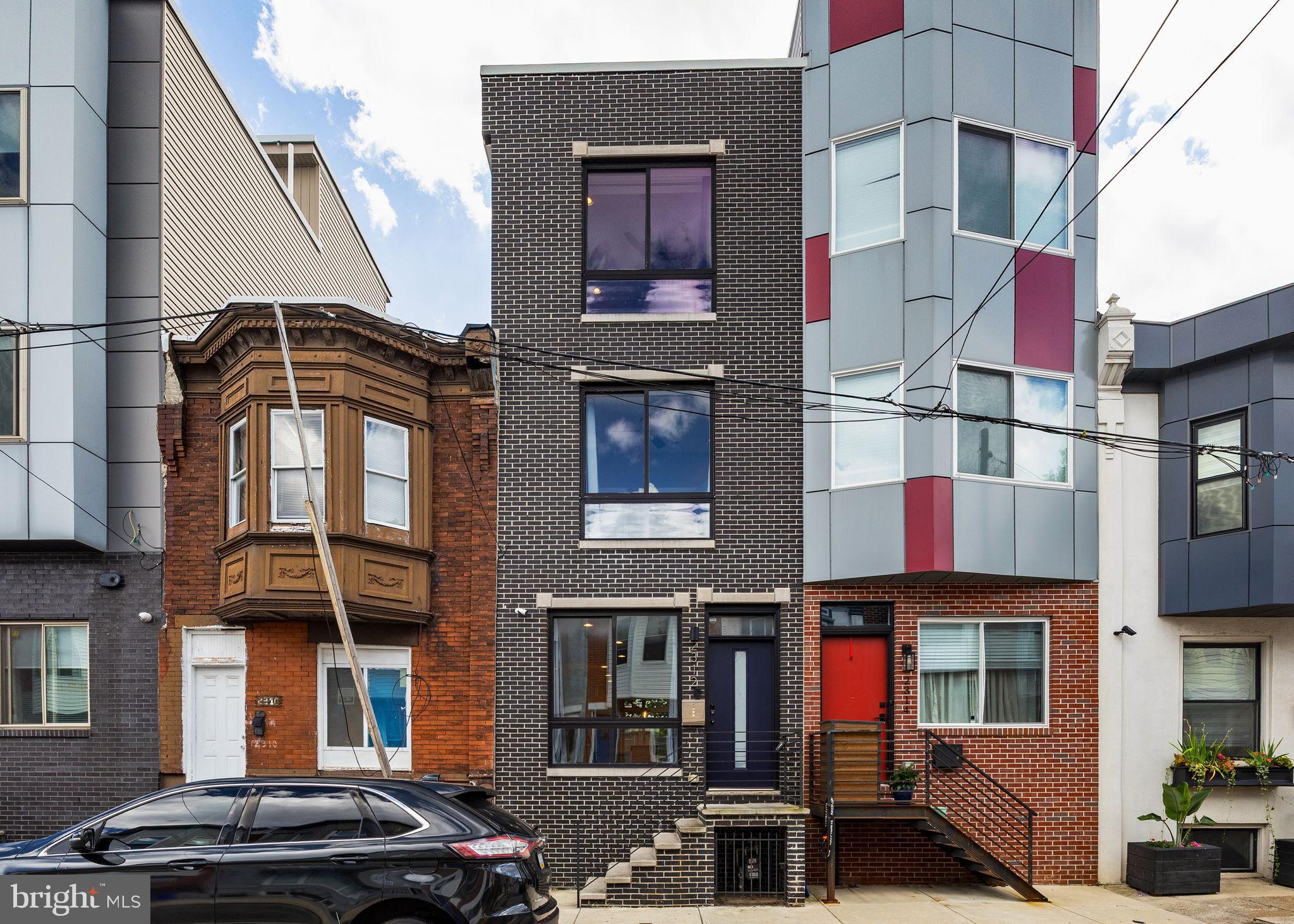 Step into modern sophistication in this 3-bedroom, 3-bath Point Breeze home, where design and comfort blend seamlessly. Built in 2020 and still benefiting from approximately half of the full tax abatement, this residence offers a rare opportunity to enjoy new-construction living with lasting value. From the moment you enter, natural light pours through oversized windows, illuminating sleek finishes and thoughtful details. The main level sets the tone with a striking modern kitchen featuring granite countertops, under-cabinet lighting, and stainless steel appliances. Bullnose corners, recessed lighting, and built-in speakers elevate the atmosphere, while the open layout flows effortlessly into a shaded back patio, perfect for outdoor dining or relaxing evenings. Upstairs, all bedrooms offer generous closet space, with the expansive third-floor primary suite as the showstopper: two walk-in closets, sweeping skyline views, and a spa-like private bath create a true retreat. The laundry is conveniently tucked into a dedicated closet on the second floor. The lower level expands your possibilities with a fully finished space complete with its own full bath. A closed-door room here is ideal as a fourth bedroom, home office, gym, or creative studio. When it’s time to entertain, invite guests up past the fully equipped wet bar to the rooftop deck. Recently serviced and freshly coated, it features built-in speakers and delivers breathtaking 360° views of the city- your own private perch above Philadelphia. With new systems throughout (all 2020), luxury finishes at every turn, and a flexible layout designed for modern living, this home is ready to be the backdrop for your next chapter.