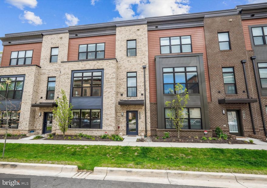 3956 Cranes Bill Court is an exceptionally maintained over 3,000 sq. ft. elevator townhome built by EYA in 2022 that has been upgraded to the highest standards to promote ease of living in the desirable Reserve at Tower Oaks community.  A gracious foyer at the main entry leads to a first-level bedroom suite or office with frosted-glass French doors.  The spacious two-car garage with durable epoxy flooring is accessible on this level.  Beautiful engineered hardwood flooring continues throughout to the main living level, which features two living spaces, a dining space, the gourmet kitchen complete with high-end quartz countertops, a built-out pantry, upgraded tile backsplash, Bosch and Wolf appliances, a center island with storage on either side, deep stainless steel sink, and under-cabinet lighting.  A powder room for guests, a gas fireplace,  and access to the deck with views of Woodmont Country Club complete this level.  Upstairs is an expansive primary bedroom suite with two custom-built-out walk-in closets and a luxurious bath with an upgraded tile shower and dual sink vanity.  This level is complete with a large second bedroom with an ensuite bath and a separate laundry room with sink, storage, and built-in ironing board complete this level.  The sunny and beautifully appointed fourth level includes a bedroom suite with a full bath, a loft/recreation room, and access to the gracious roof deck with special porcelain tile flooring.  Other unique features include a rough-in for an EV charger in the garage, halo mirrors in each bath, full security system, whole-house WiFi system, and mechanized solar and black-out shades for the 2nd and 3rd levels.
The Reserve at Tower Oaks community is rich in amenities and offers a multi-space clubhouse that can be rented out for private events, an outdoor pool, a grilling area, a fitness center, and a sport court.  Ideally located near Woodmont Country Club,  landmark Clyde's Tower Oaks Lodge restaurant, Park Potomac shopping and dining, I-270 and Rockville Pike, this residence represents a rare opportunity to live in an ideally positioned and elegant home.