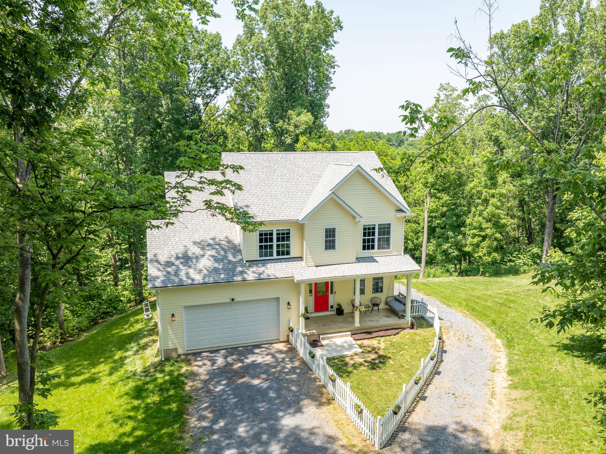Welcome to 167 Hyde Park Lane, a stunning 2022-built home nestled on over 2.5 private acres in the peaceful, established river community of Avon Bend in Charles Town, WV. Tucked away at the end of a quiet cul-de-sac and surrounded by a partially wooded lot, this beautifully designed property offers the perfect balance of privacy, nature, and community charm. This spacious 4-bedroom, 3.5-bath home boasts soaring ceilings on the main level and an open-concept layout ideal for everyday living and entertaining. The heart of the home features a modern kitchen with granite countertops, an adjoining dining area, and a cozy living room with a gas fireplace. A dedicated office and a convenient powder bath complete the main floor. The main-level primary suite is a true retreat, showcasing tray ceilings, a large walk-in closet, and a luxurious en suite bathroom with dual granite vanities and an oversized walk-in shower. Upstairs, you’ll find two generous bedrooms that share a buddy bath, offering both space and functionality. The fully finished lower level is filled with natural light and is perfectly set up as an in-law suite. It includes a full kitchen, private laundry, spacious living area, bedroom with walk-in closet, and a full en suite bath—ideal as an in-law suite. Step outside and enjoy the peaceful surroundings from your back deck, or take advantage of the private, gated river access to the Shenandoah River—perfect for paddle boarding, kayaking, fishing, and swimming. Avon Bend also features a well-maintained community park with playground equipment. This home truly has it all—privacy, space, and access to the outdoor lifestyle you’ve been looking for. Call today to schedule your private tour!