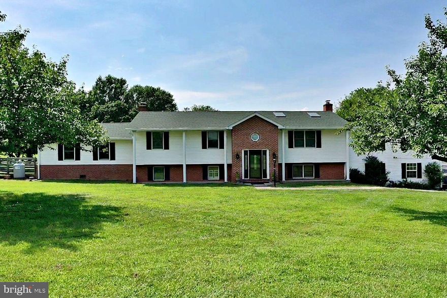 Spacious Split foyer custom built home with over 3000 sq ft and situated on two acres with two car garage and inground pool. Property features three bedrooms (septic), four bathrooms, three additional rooms could be used as bedrooms (6 in total), two primary bedrooms with full baths, three fireplaces (two gas and one woodburning), molding upgrades, multiple built in shelving/bookcases, tile flooring, upper level laundry room and lower-level laundry room with steam shower, Living room with vaulted ceiling, gas fireplace, and skylights with built in blinds. Kitchen has 42 in cabinets, ample extra cabinetry space, SS appliances, and more.  Foyer has custom hardwood flooring, exposed beams, and built in area.  Primary bedroom has gas fireplace, custom built in bookcase, cedar lined closets and a jet tub.  Multiple decking and above garage there is a workshop.  The Primary bedroom, garage, and the workshop all have mini split units as well. Located near the Sam Michaels Park and close to all MD VA commuter corridors.