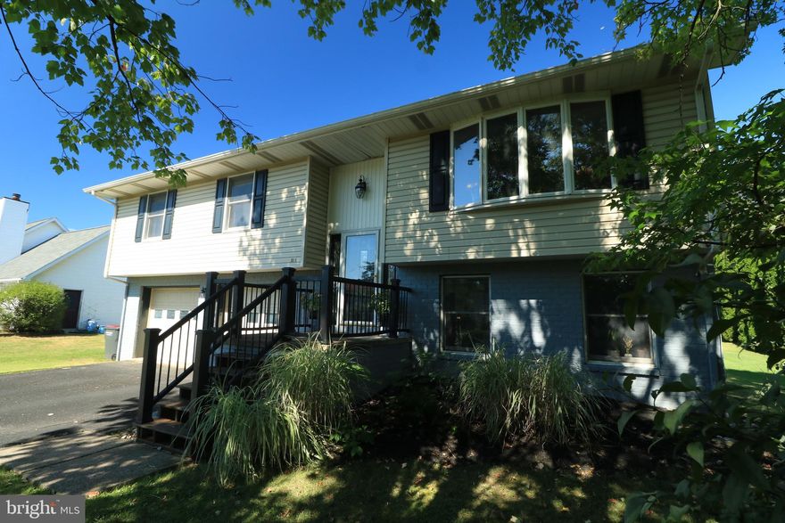 OPEN HOUSE: Sun, Mar 22 1:00 PM - 3:00 PM | Come home to 311 Goldfinch Drive!  This well maintained, move-in ready home features generous room sizes, many updates, and a spacious yard.  Enjoy plentiful sunshine through the large bow window in the sizable living room.  The adjacent kitchen / dining combo boasts an open layout, stainless steel appliances, a breakfast bar, new light fixtures, and a sliding door to the large deck for BBQ's and alfresco dining.  The bright primary suite boasts two closets and an ensuite full bath, while two additional bedrooms and a hallway bath with dual sink vanity complete the main floor.  Downstairs the spacious and sunny family room provides entertainment and recreation space and comes complete with a half bath and a walk-out to the backyard.  An ample sized laundry room and a large two car garage round out the lower level.  The many updates include a newer roof, new central air system, an expanded deck, new front steps and stoop, smart switches and thermostats, a new water heater, and newer appliances.  Have fun playing in the flat, open backyard that offers privacy with evergreens to the rear and enjoy the lovely landscaping.  With a park down the road, bike path access to the rear, hiking at nearby Mt. Nittany, and Centre Hills Golf Course down the road, recreational opportunities abound.  Close to the Village of Lemont with it's shops, coffee shop, restaurants and breweries and not far from from downtown State State College & Penn State's Campus.