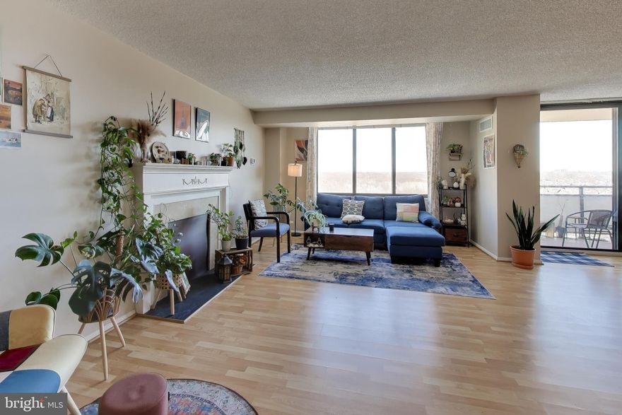 Welcome home to this bright and spacious apartment with oversized windows and a beautiful view overlooking the Promenade’s outdoor pool and treed panorama. Natural light pours into the open living and dining areas, creating an easy, airy flow that extends right out to the private balcony—the perfect spot to relax and enjoy the energy of the pool below, giving the feel of a resort getaway right at home.

The apartment features durable manufactured wood flooring throughout the main living spaces, offering both style and practicality. The living room includes a charming mantel, adding warmth and character. A tiled entry hallway offers generous storage with multiple closets, including a walk-in closet with built-ins.

The updated kitchen is thoughtfully laid out with granite countertops, crisp white cabinets, tiled flooring, and stainless finishes.

The recently renovated full bath feels fresh and stylish, featuring a walk-in glass shower, pedestal sink, tiled flooring, two mirrored medicine cabinets, and designer accents. A full-length mirror on the exterior door adds both function and flair.

The generously sized bedroom offers comfort and space, complete with a roomy walk-in closet.

Living at the Promenade means enjoying true resort-style amenities. Residents have access to a state-of-the-art fitness center, indoor pool, hot tub, sauna, locker rooms, and an impressive arcade level featuring on-site dining, grocery/deli, dry cleaning, salon services, travel services, and multiple party and conference rooms. Outdoors, enjoy the beautifully maintained pool area with barbecue stations, plus a separate recreation building with tennis courts, pickleball, ping pong, and more.

The community offers an active social calendar with events and activities including trivia nights, open mic nights, movie screenings, lectures, wellness programs, book clubs, games, and fitness classes—there’s always something happening.

Conveniently located for both daily commuting and everyday errands, the Promenade offers exceptional access to public transportation and major roadways. The Red Line Medical Center Metro station (NIH/Walter Reed) is easily accessible, and bus service stops right at the front door of the building, making trips into downtown Bethesda, Washington, DC, and surrounding areas simple and stress-free. For drivers, the location is just minutes from I-495 (the Beltway) and I-270, providing smooth connections to DC, Northern Virginia, and points throughout Montgomery County. Nearby shopping, dining, and essentials are all close at hand, making this home as practical as it is enjoyable. Co-op ownership; purchase subject to co-op approval.