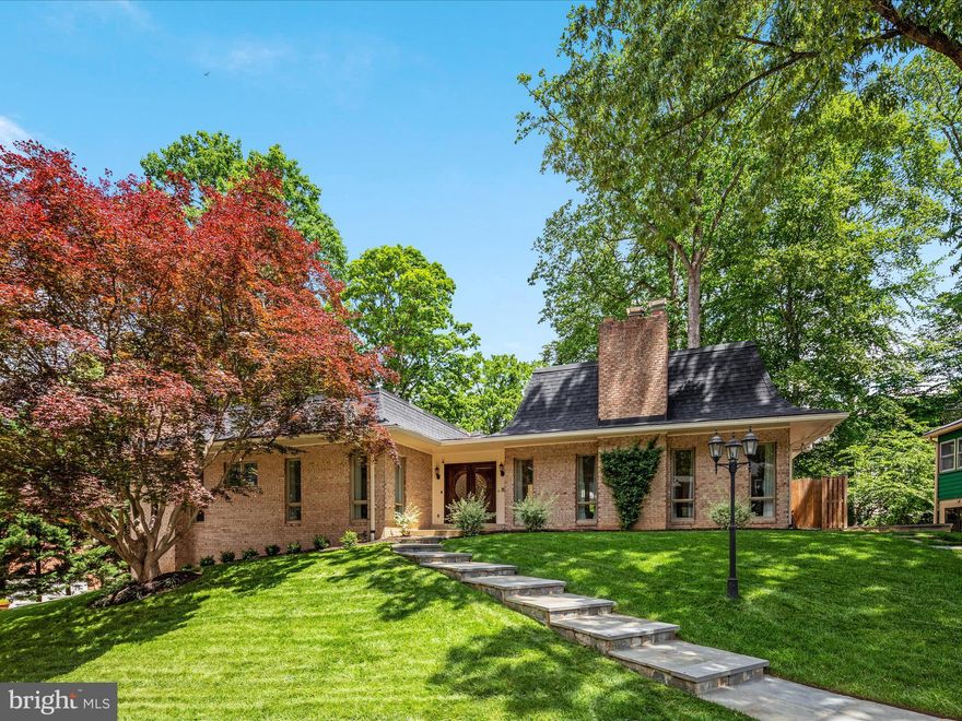 Welcome to this exquisitely renovated 4-bedroom, 3.5-bath home in the sought-after Chain Bridge Forest neighborhood, just one stoplight to Washington, DC. Located on a peaceful, sidewalk-lined, no-thru street, this home offers main-level living, luxurious updates, and expansive outdoor space that brings a relaxed, resort-like vibe—perfect for enjoying the best of indoor and outdoor living.

As you arrive at this elegant residence, newly constructed flagstone steps illuminated by integrated LED lighting welcome you with warmth and beauty. Stepping inside, the spacious foyer opens into the impressive Great Room with soaring ceilings, tall windows, and a striking wood-burning fireplace. The heart of the home is the fully renovated gourmet kitchen, featuring white quartz countertops, soft-close cabinetry, a decorative glass tile backsplash, and stainless steel appliances—including a 5-burner gas stove with range hood and a farmhouse sink. The adjacent sun-filled Family Room includes an electric fireplace, and the Dining Room offers plenty of space for both formal and casual gatherings.

The main level also features a generously sized Primary Suite with multiple closets and a spa-inspired bathroom with dual vanities and a walk-in shower. A large second bedroom, an elegant office (easily converted into a third bedroom), a renovated hallway bathroom with a walk-in shower, a stylish powder room, and a large laundry room with built-ins and a utility sink complete the main level. The kitchen, doors, baseboards, and fresh paint were all updated in 2023, with bathroom renovations completed in 2017.

The fully renovated lower level (2023) offers 9-foot ceilings, two spacious bedrooms, a remodeled full bath, and a separate kitchenette—making it ideal for guests, extended family, or long-term visitors. Large windows throughout this level provide lovely backyard views and an abundance of natural light.

For those desiring even more space, nearly 500 sqft of unfinished square footage—with high ceilings, a fireplace, full-sized windows, and plumbing rough-in for a future bath—offers excellent potential for customization and expansion.

Step outside to the massive flagstone terrace, recently redesigned and ideal for year-round outdoor enjoyment. Whether for morning coffee, grilling out, or hosting friends and family, this space is complemented by uplighting, LED step lights, solid iron railings, and a new irrigation system.  Newly placed sod and stunning bushes landscape the backyard.

Other notable features include: Extensive recessed lighting (2023), Roof (2022), Gutters with LeafGuard (2023), Hot water heater (2023).

This home is ideally located near Arthur Boulevard, Chain Bridge, Chesterbrook Shopping Center, the GW Parkway, Arlington, downtown McLean, Falls Church, and Tysons. Enjoy being part of the highly desirable McLean High School pyramid with easy access to Reagan and Dulles airports. Don’t miss your chance to own this showcase property, featuring major renovations and a fantastic location!