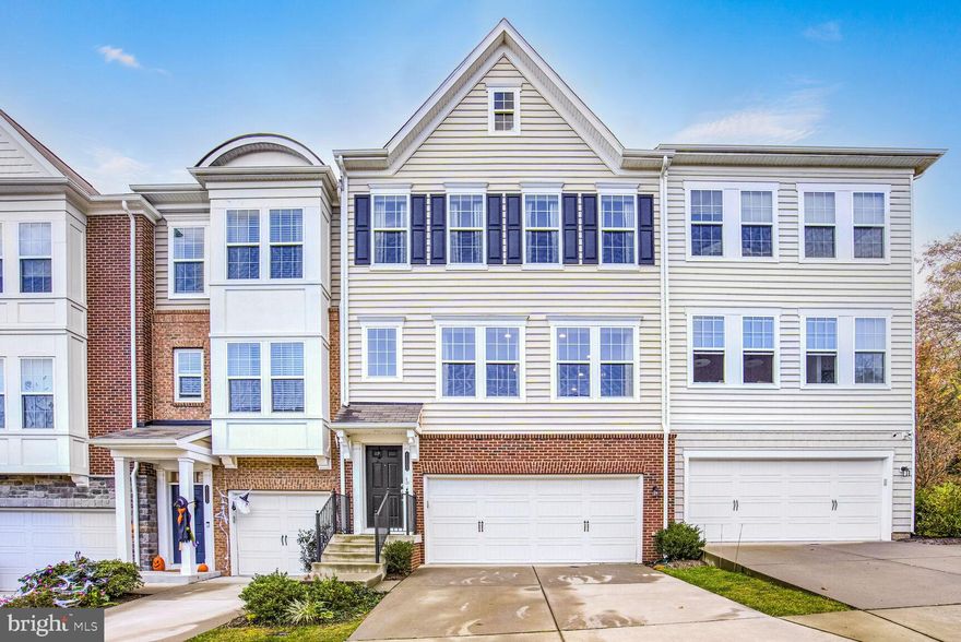 Experience the best of Ashburn living in this stunning townhome, nestled in the desirable River Crest community. This spacious and thoughtfully designed home offers a perfect blend of style, functionality, and convenience. Arrive into the main level’s great room-style open floor plan, offering versatility for both entertaining and day-to-day relaxation. The gourmet kitchen is a home chef’s dream, featuring a huge granite island with extensive bar seating, abundant cabinet and pantry storage, and a suite of quality stainless appliances including a new Samsung refrigerator in 2022. Seamlessly transition to your formal dining space, filled with natural light from four large windows, creating the perfect setting for your next gathering. The adjoining family room beckons for conversation and cozy movie nights, while a built-in office nook creates a great work-from-home space. The main level continues into a bumpout den with sliding doors to your durable Trex deck with an upgraded Sunsetter awning, creating an effortless indoor-outdoor flow. Contemporary lighting and upgraded wide-plank engineered hardwood floors add a touch of modern luxury throughout the home. Upstairs, retreat to your impressive primary suite featuring a private sitting area, generous walk-in closet, and an updated spa-like primary bath with dual sinks and an oversized frameless shower. This level also hosts two more generously sized bedrooms, each with upgraded ceiling fans, plus a full bath in the hall, and your laundry thoughtfully placed near the bedrooms for added convenience. The lower level offers even more flexible living space, with a living room featuring a sliding door walk-out to the patio, hot tub, and fully fenced backyard, landscaped with low-maintenance plants. A fourth bedroom with a full bath ensuite provides the perfect guest suite, and this level also has access to the attached 2-car garage, complete with a 220-volt EV charging station and additional storage. Nestled in an outstanding Ashburn location, this property is close to Routes 7 and 28, Dulles Airport and George Washington University, and just across from the 124-acre Bles Park with scenic trails to the Potomac River. With diverse local dining, shops, and all the amenities of One Loudoun just minutes away, this stunning townhome offers the perfect combination of luxury, comfort, and accessibility. Welcome home!