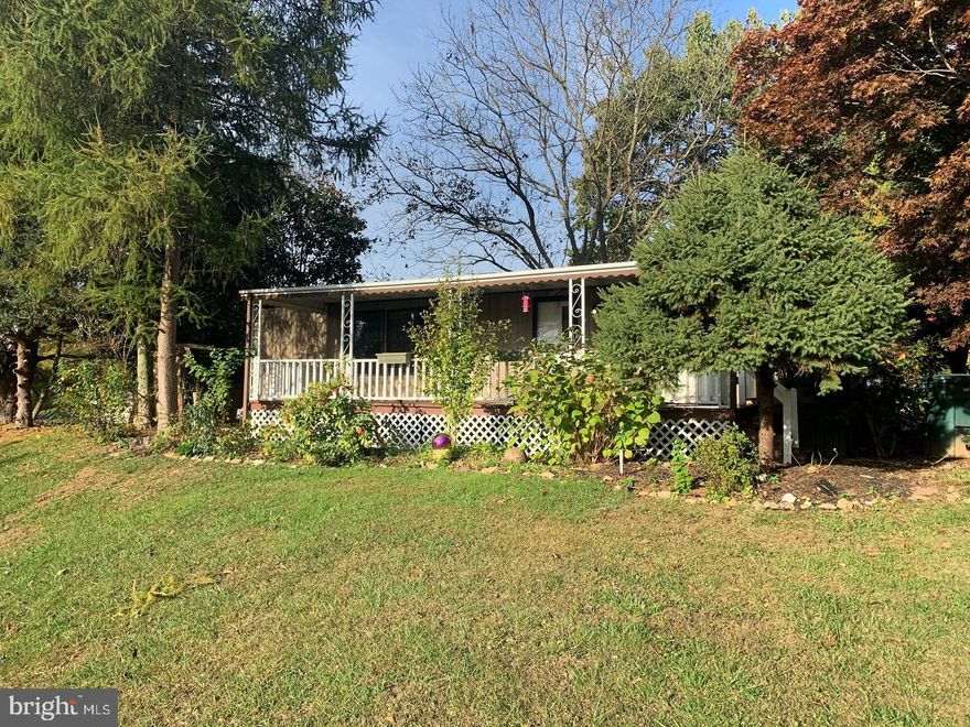 Enjoy the large covered porch among mature trees on a quiet street in Heritage Estates. The natural light in this 1986, 2 bedroom mobile home is very inviting. Newer flooring and all appliances stay with this home.