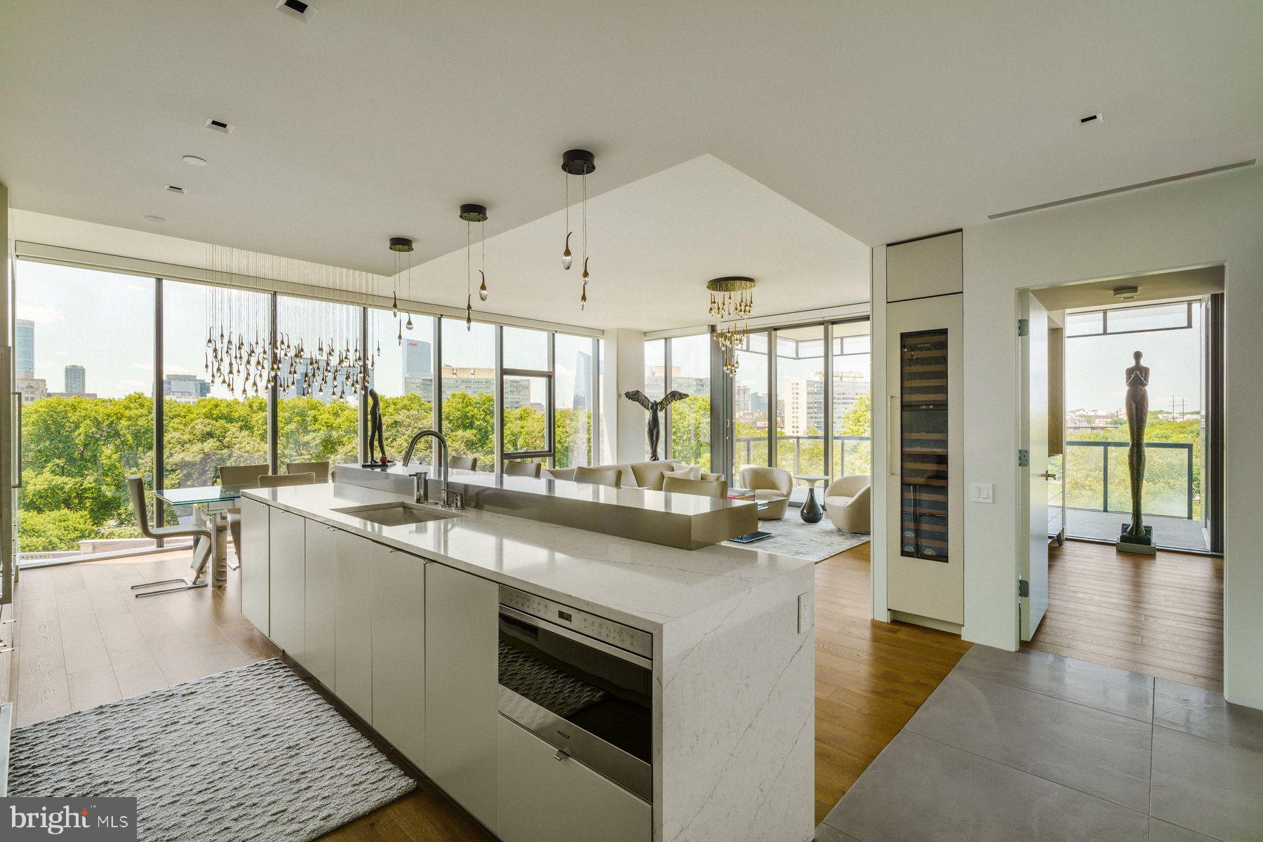 Welcome to Unit 6A at 2100 Hamilton, a residence that defines luxury living in the heart of Philadelphia’s Art Museum District. Spanning 2,163 square feet, this 3-bedroom, 3.5-bath home has been extensively upgraded with over $425,000 in high-end customizations and furnishings, offering an unparalleled turnkey lifestyle. Every room enjoys panoramic views of the Philadelphia skyline and the iconic Philadelphia Museum of Art through floor-to-ceiling windows outfitted with custom window treatments and designer finishes. A fully integrated Crestron and Lutron system—installed and supported by Creative Systems—controls lighting, shades, audio, security cameras, video gaming, Apple TV, and cable, creating seamless control and ambiance throughout the home.
The main living space is thoughtfully designed for both comfort and entertaining, anchored by a gas fireplace and flanked by an elegant dining area and automated sliding doors that open to a private, heated terrace with full WiFi connectivity. The Joanne Hudson-designed kitchen is a showpiece of style and function, with upgraded stone finishes, sleek two-tone cabinetry, a Wolf induction cooktop, and a complete Wolf/Cove appliance suite. Just off the kitchen, a separate entertaining area adds flexibility and convenience.
The serene primary suite offers a peaceful retreat with a gas fireplace, ceiling fan, dual custom-designed walk-in closets, and a spa-like bathroom featuring radiant heated floors, dual vanities with ample storage, and a spacious walk-in shower. Two additional en-suite bedrooms provide versatility, with one currently configured as a designer guest room—complete with a tub/shower combination—and the other as a sophisticated home office. Each space is appointed with curated furnishings and bespoke artwork that elevate the home’s overall aesthetic.
Additional upgrades include extensive builder-level electrical enhancements, custom painting and wallpaper, and fully customized closets throughout. The home also includes two dedicated parking spaces and benefits from a remaining seven years on the Philadelphia tax abatement.
2100 Hamilton delivers an unmatched amenity package, including a private residential garden and event plaza designed by landscape architects Sikora Wells Appel, a heated indoor infinity pool, state-of-the-art fitness center, boardroom, guest suite, catering kitchen, amenity lounge, and 24-hour concierge service. A private town car with driver is available to residents, and a facial recognition elevator offers secure, direct access from the valet garage to your front door. A valet fee of $350/mo.
Every detail of Unit 6A has been meticulously considered and beautifully executed, creating a residence that is as functional as it is visually stunning. Don’t miss this opportunity to own a move-in-ready, best-in-class home in one of Philadelphia’s most exclusive addresses.