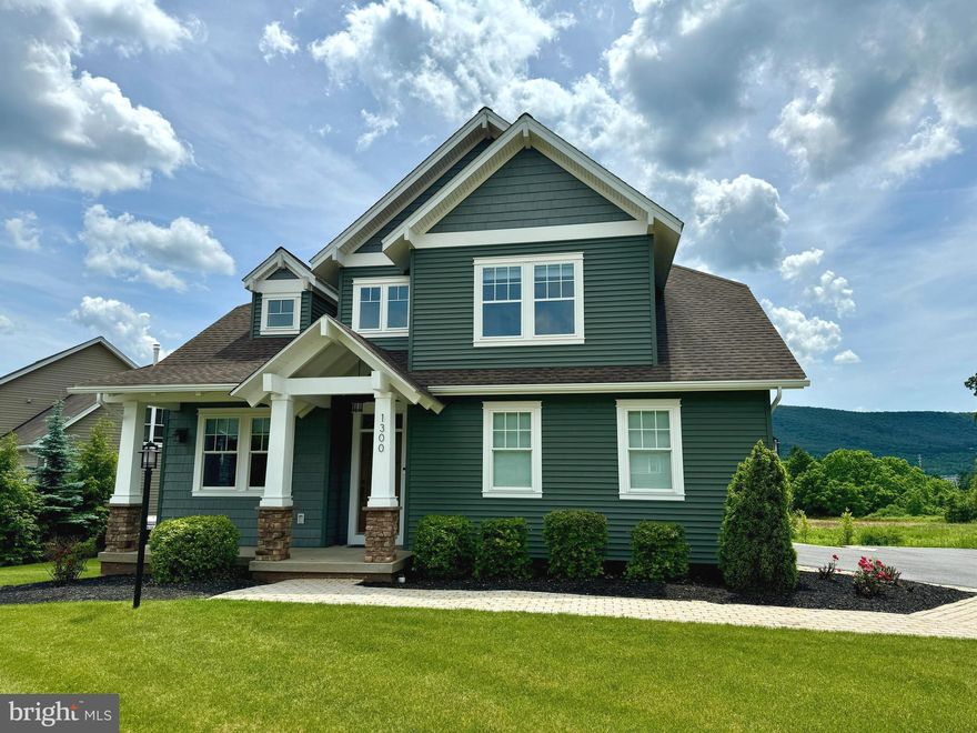 Stunning Craftsman Style Two-story.  Nestled within the picturesque Rockey Ridge subdivision with unparalleled views of Tussey Mountain, this meticulously maintained move-in ready home delivers eye-catching curb appeal with its stylish exterior & welcoming covered front porch.  The inviting interior offers a plethora of upgrades to include beautiful hardwood floors, 9’ ceilings, solid wood doors, custom trim, chic light fixtures & large windows that flood the home with an abundance of natural light.  The thoughtful open concept design floorplan delivers a home office & half bathroom.  The chef envy kitchen comes complete with included top of the line stainless appliances, stunning solid wood cabinetry, under cabinet lighting, Granite countertops, large stainless range hood over the gas cooktop/range, sleek subway tile backsplash, handy work island with seating, offering the perfect spot for your morning coffee as well as the delightful dining area for serving up meals.  Off of the kitchen you will love entertaining in the spacious Great room featuring a charming floor to ceiling stone wood burning fireplace & transom windows.  The hardwood & wrought iron staircase leads you to the second floor where you will find a cozy nook area with built-ins.  The ultimate owner suite provides a relaxing space with tranquil views, private full bathroom with a dual vanity with quartz top, tile flooring, walk-in shower, soaking tub, water closet & walk-in closet with custom built-ins.  There are 3 additional nicely appointed bedrooms, another full bathroom & a convenient 2nd floor laundry room.  The finished walk-out lower level boasts a spacious family room with French doors to the lower level paver patio, home gym, an additional full bathroom with an infrared sauna.  You will appreciate the handy first floor mudroom that leads you to the side load 2 car garage.  The new wrap around deck with retractable power awing that overlooks the scenic back yard & endless mountain views.  You will appreciate the lovely landscaping & hardscape.  Additional amenities include custom Hunter Douglas power window shades, new premium heat pump, air exchanger & Central Air Conditioning.  Perfectly positioned on a .26-acre corner lot in a prime location, moments away from Mountain View Country Club, Tussey Mountain Ski & Recreation, easy access to Route 322, 2 minutes from downtown Historic Boalsburg & just 8 minutes to Beaver Stadium/Penn State University.